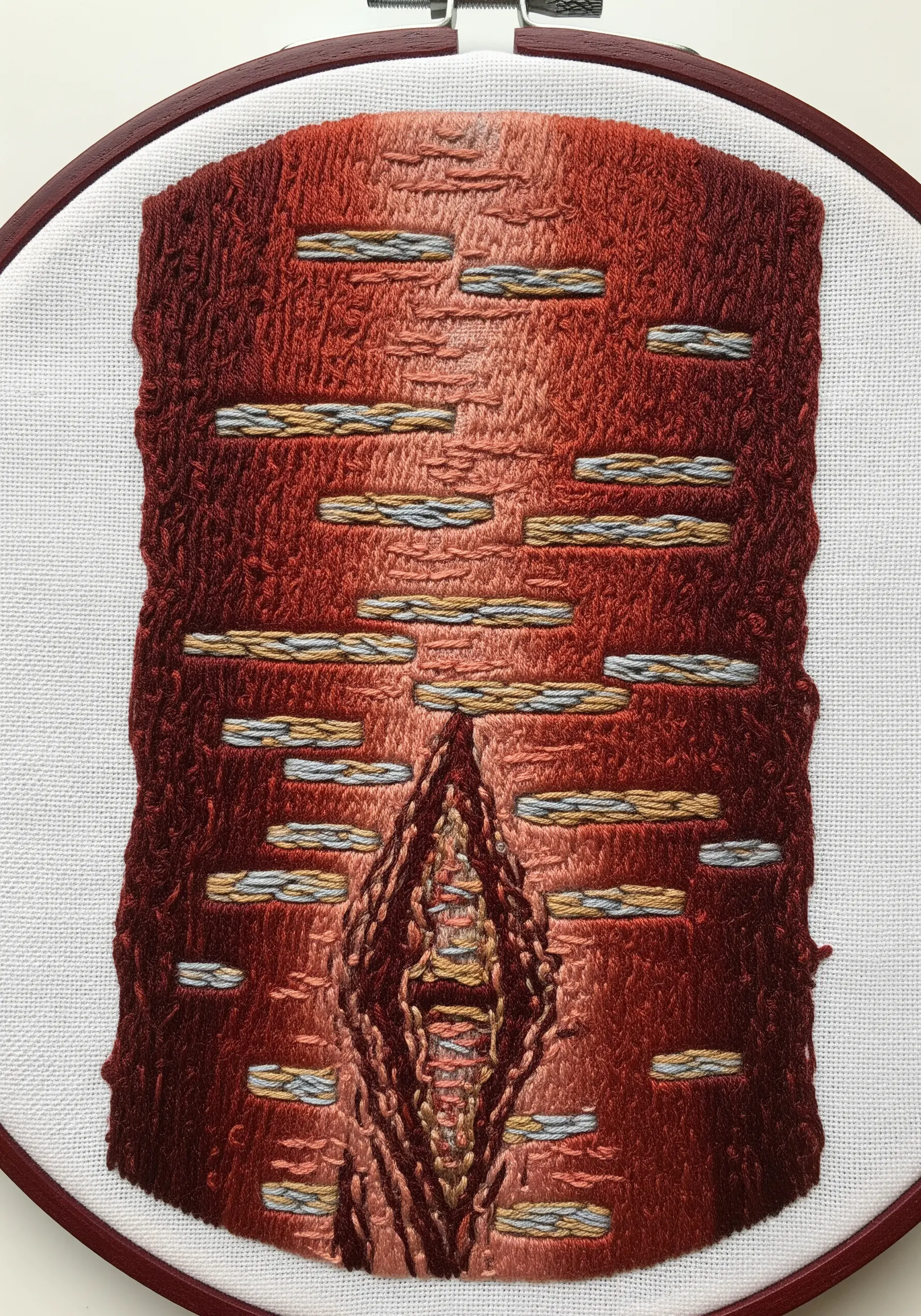 Thread-painted red bark with blended colors and contrasting horizontal satin stitches.
