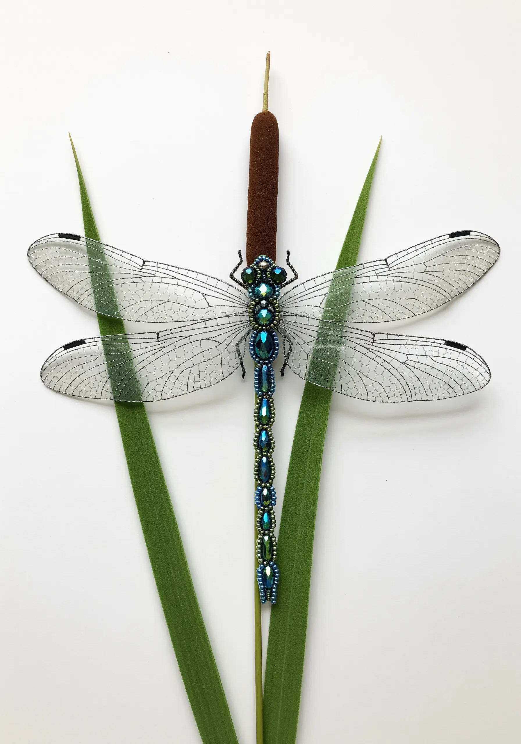 Beaded dragonfly body with translucent wings made from stitched organza.
