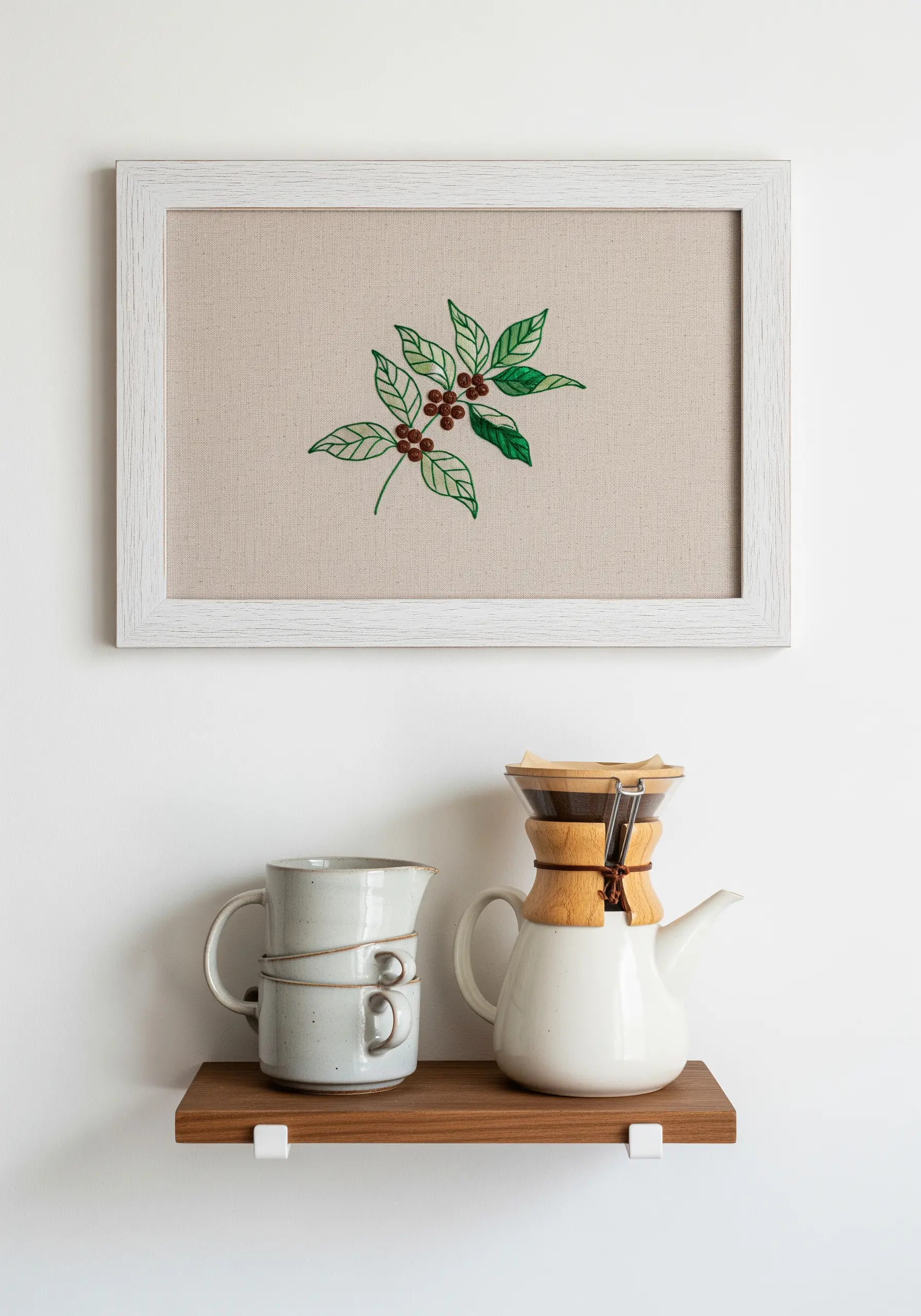 Embroidered coffee plant with green leaves and red coffee cherries.