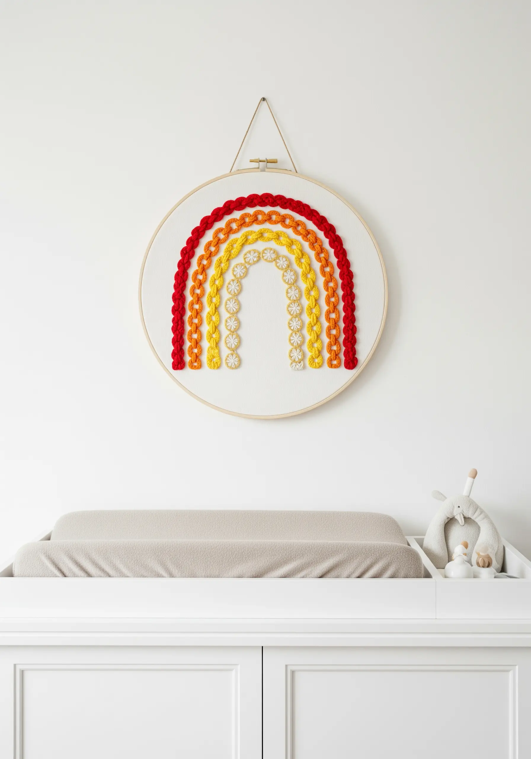 A tactile rainbow embroidered with various raised stitches in a nursery.