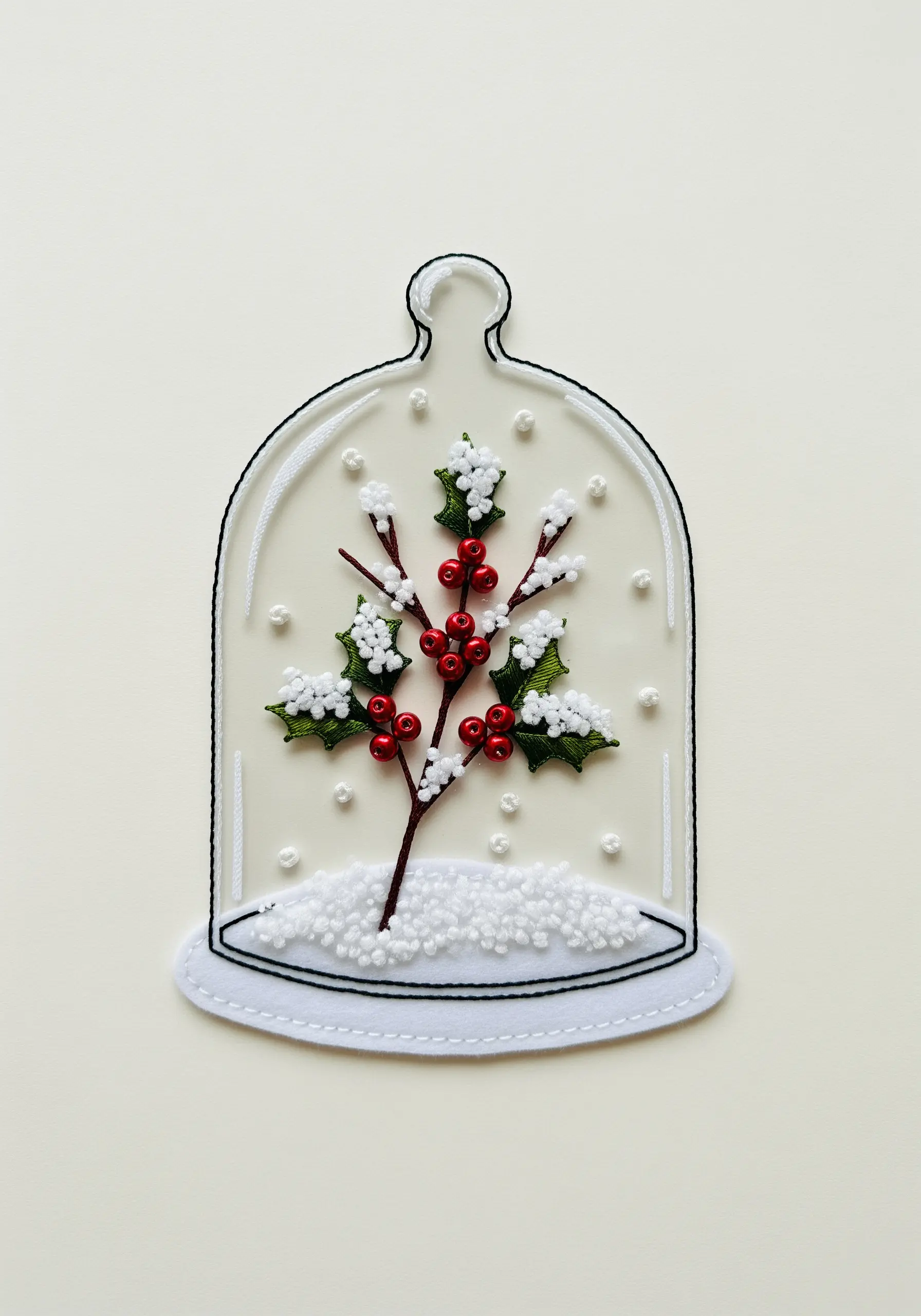 Winter terrarium with an embroidered holly branch, beaded berries, and felt snow