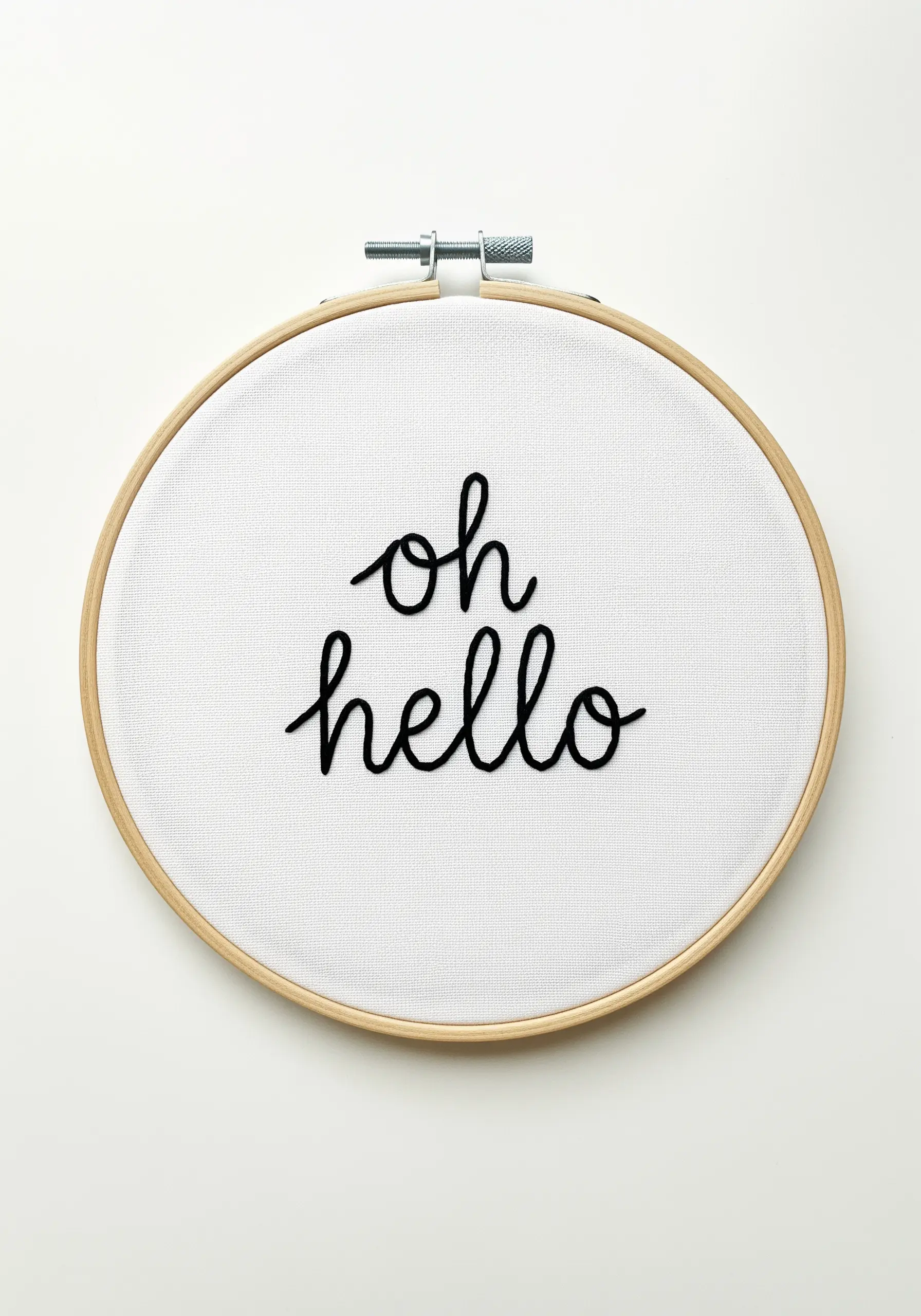 The phrase 'oh hello' in fine black modern calligraphy embroidery.