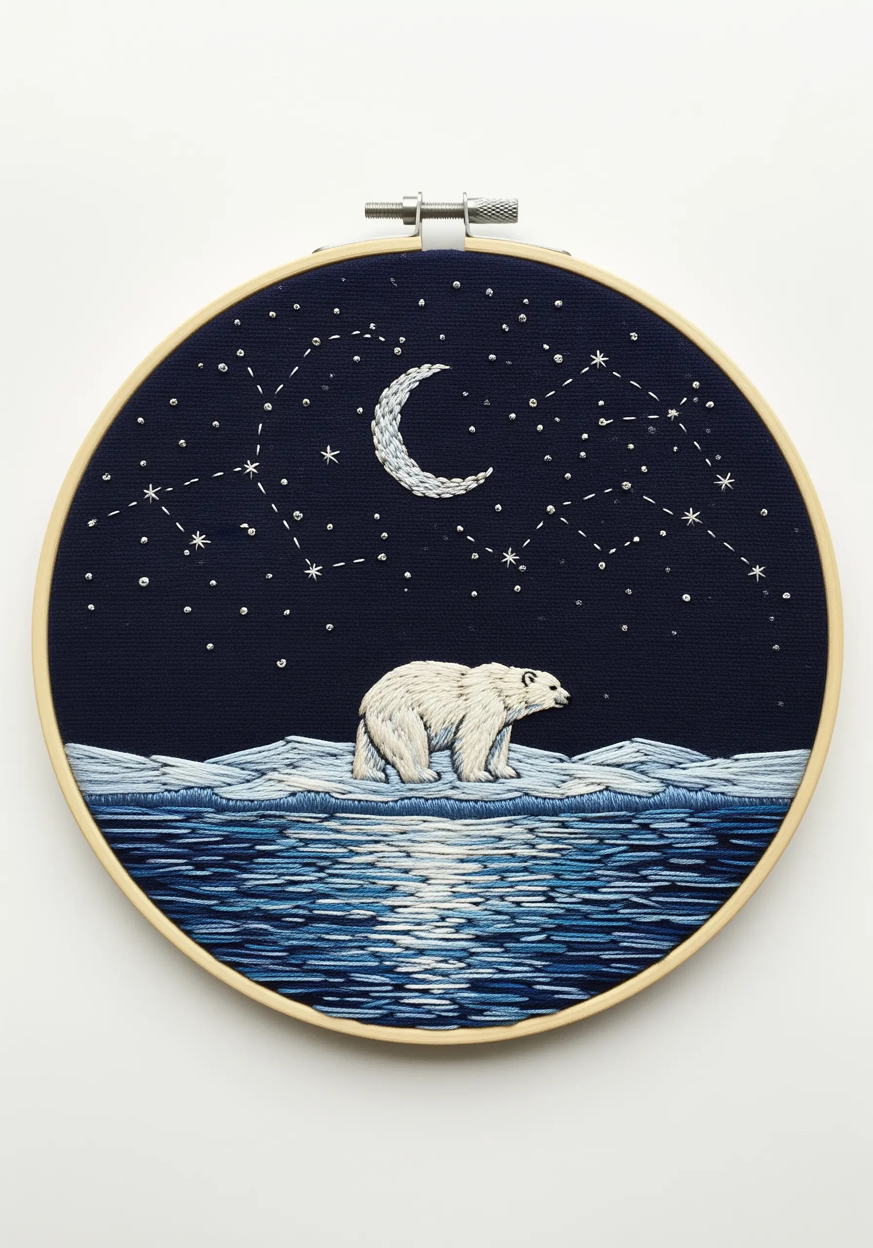 Embroidery of a polar bear on an ice floe under a starry night sky with water reflections.