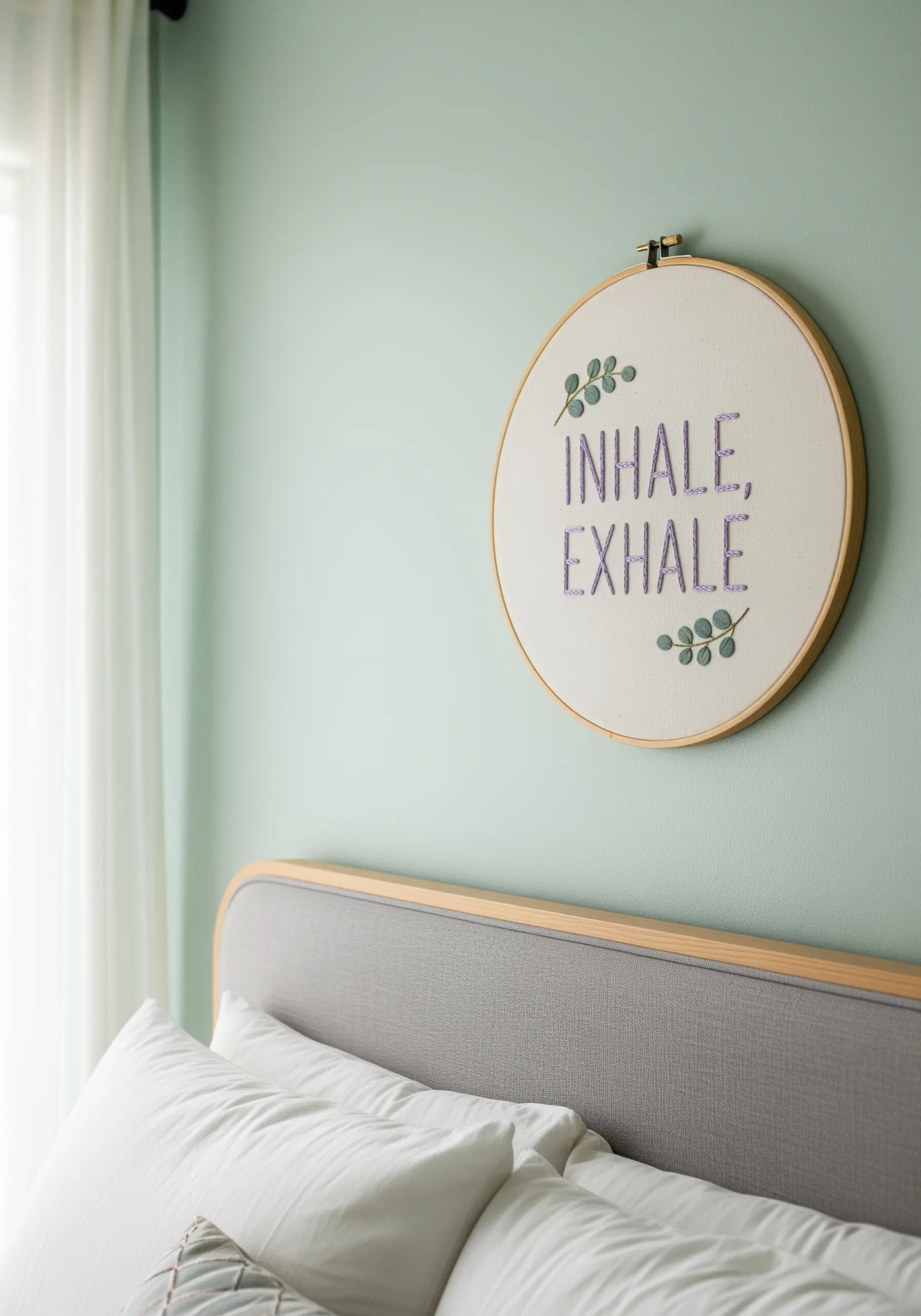 A simple quote embroidered in light purple thread, accented with small eucalyptus sprigs.
