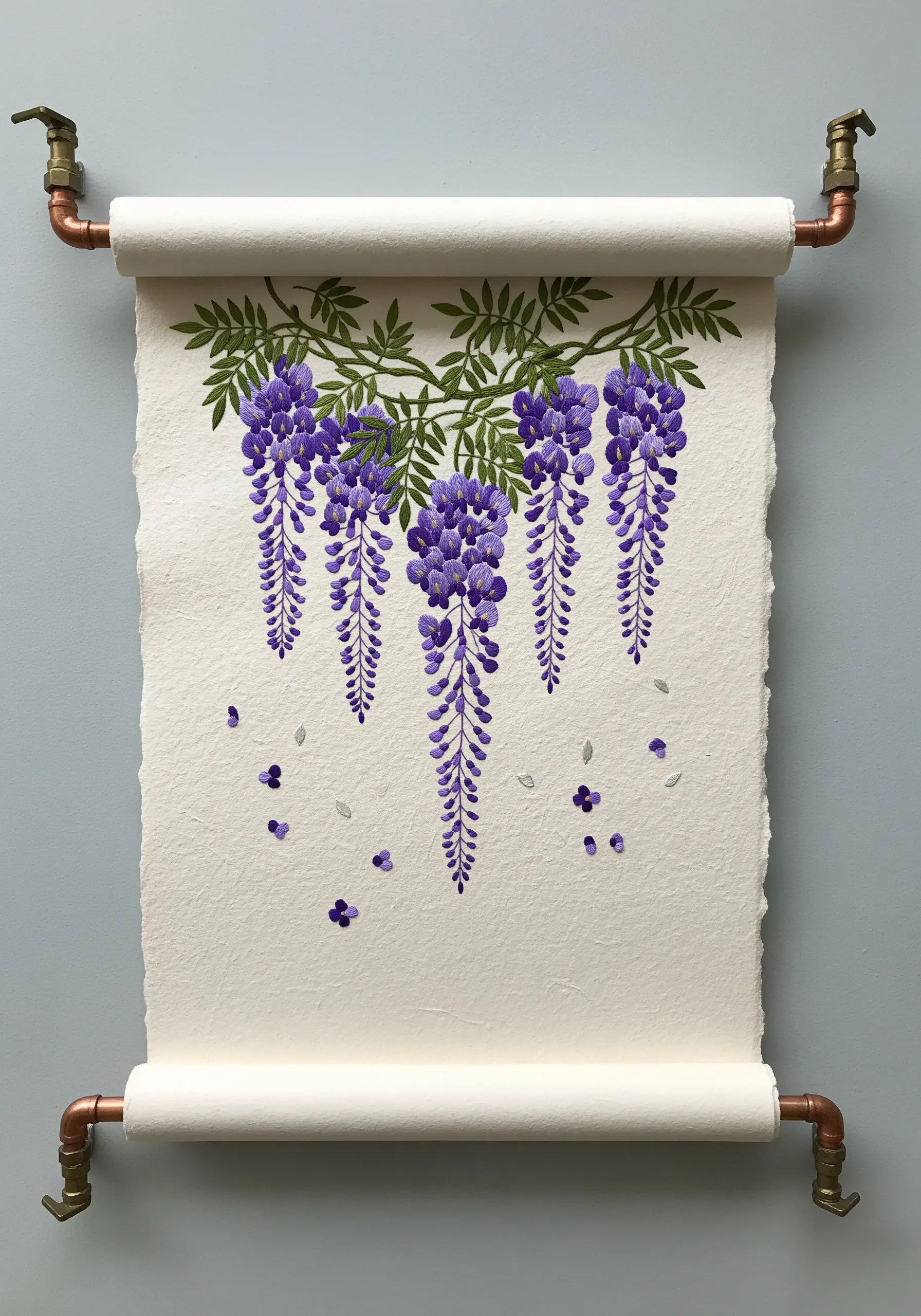 Embroidered wisteria blossoms on a handmade paper scroll hanging from copper pipes.