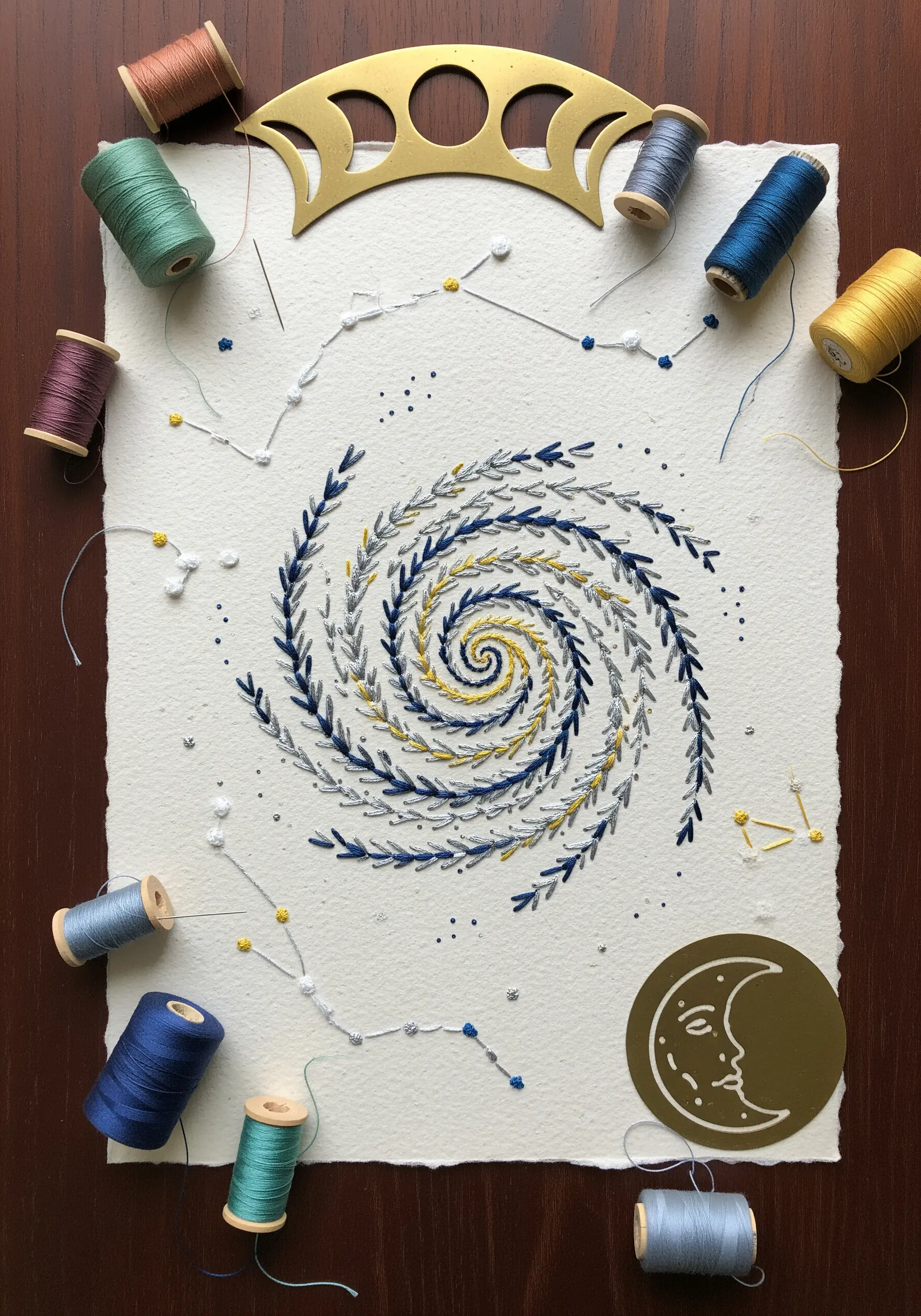 Celestial spiral and constellations embroidered on thick, deckle-edge paper.