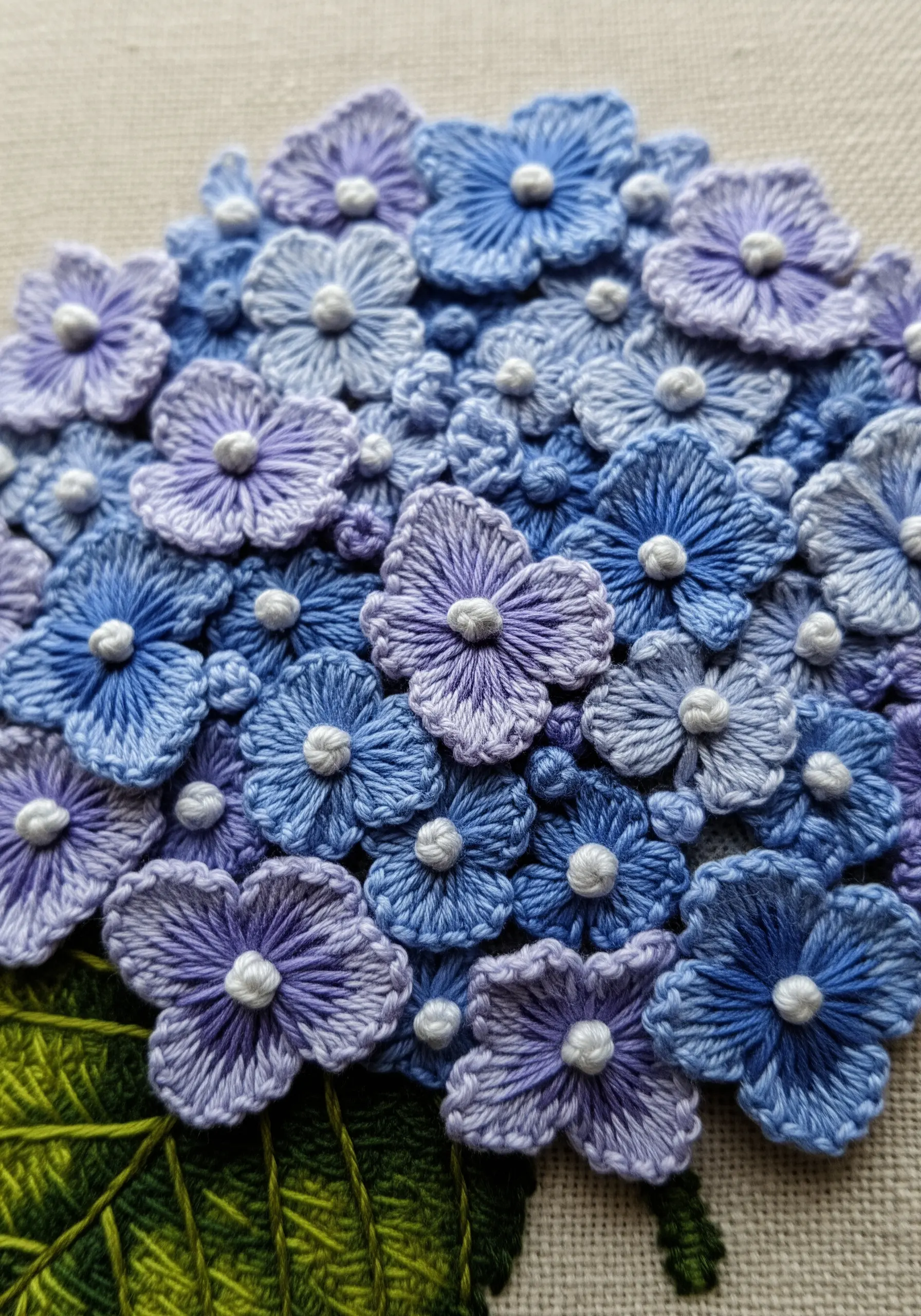 Blue and purple hydrangea embroidery made of clustered raised stitches