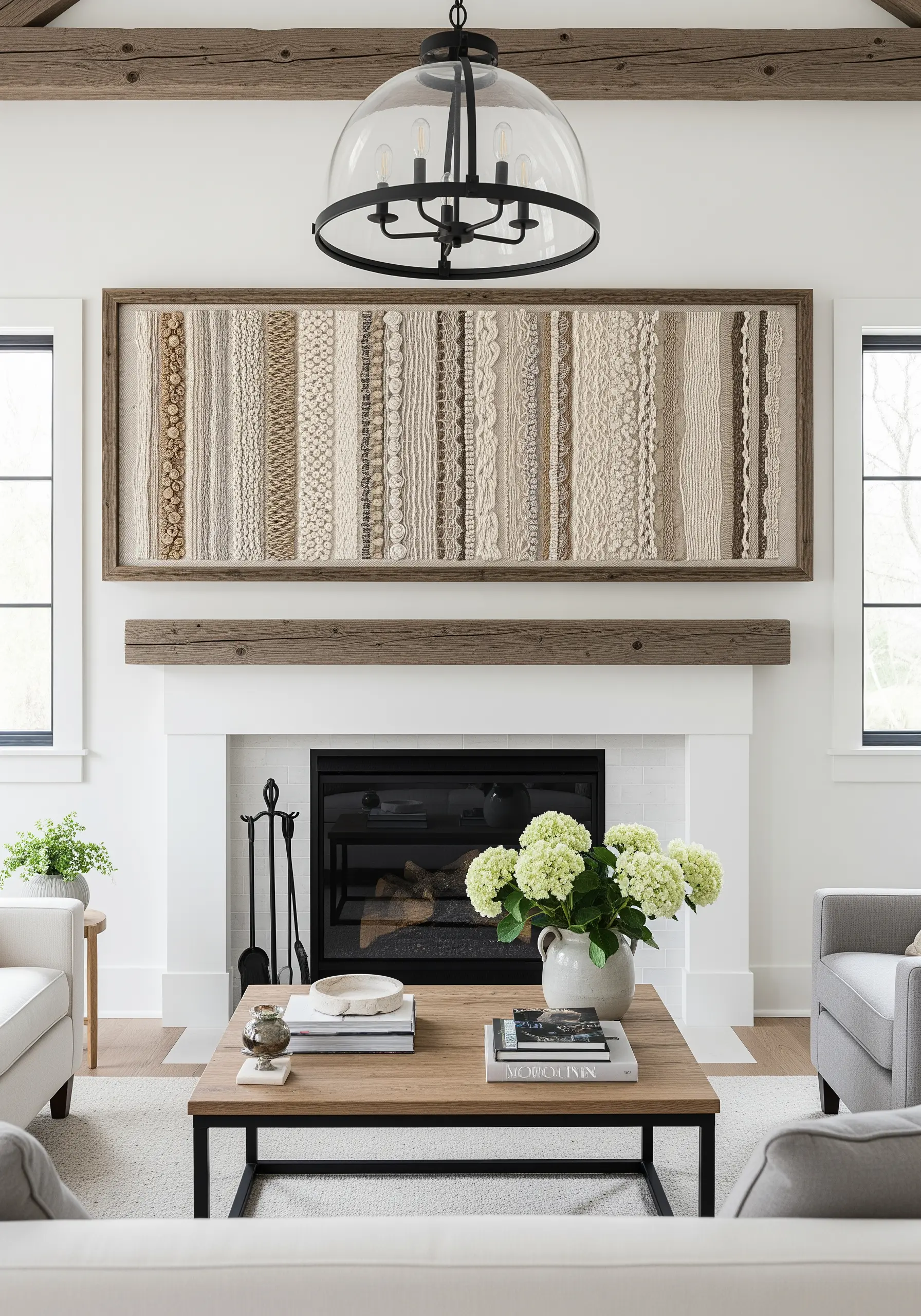 A large, framed panoramic embroidery piece with vertical bands of different neutral textures.