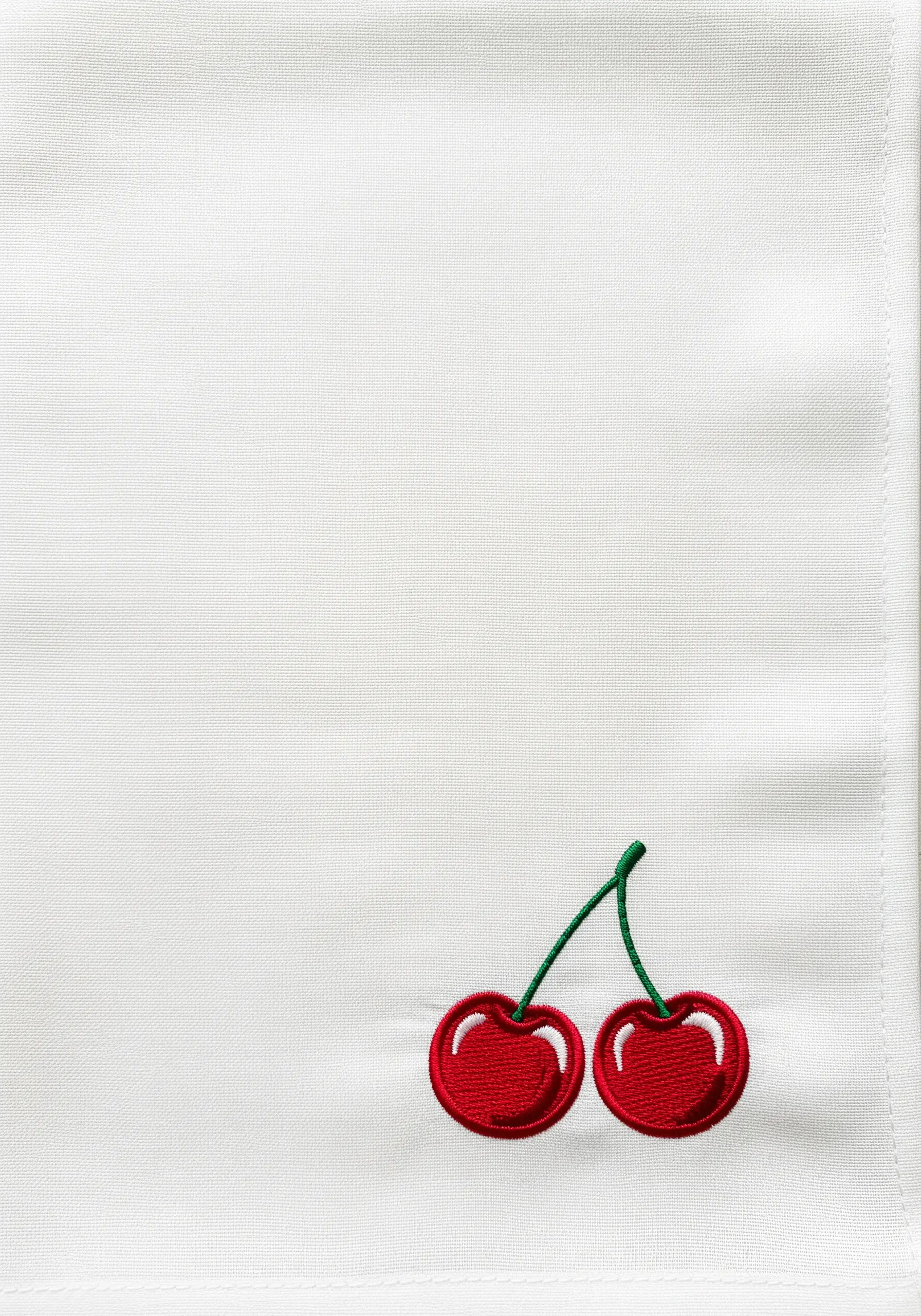 Two embroidered cherries with white highlights, stitched in the corner of a white towel.