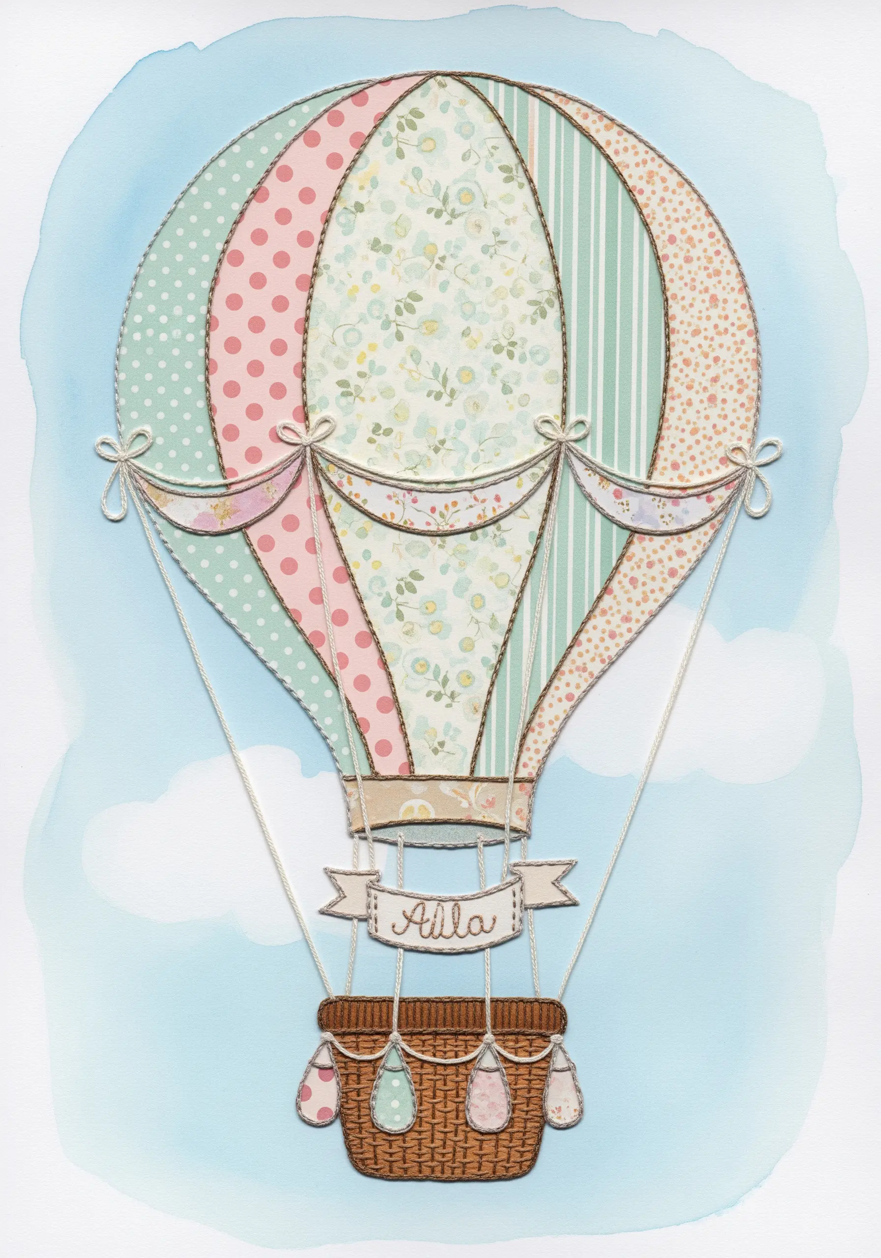 A hot air balloon made from patterned paper with stitched details, on a watercolor sky background.