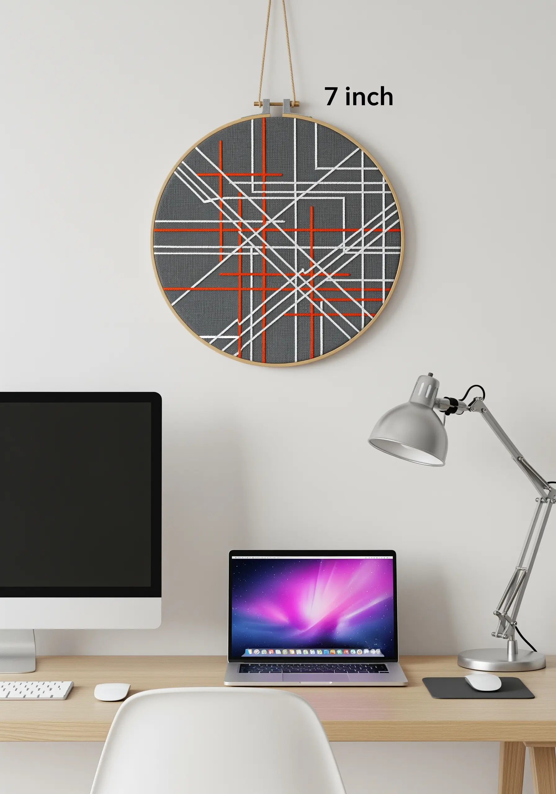 An abstract grid of intersecting straight stitches in white, gray, and orange.