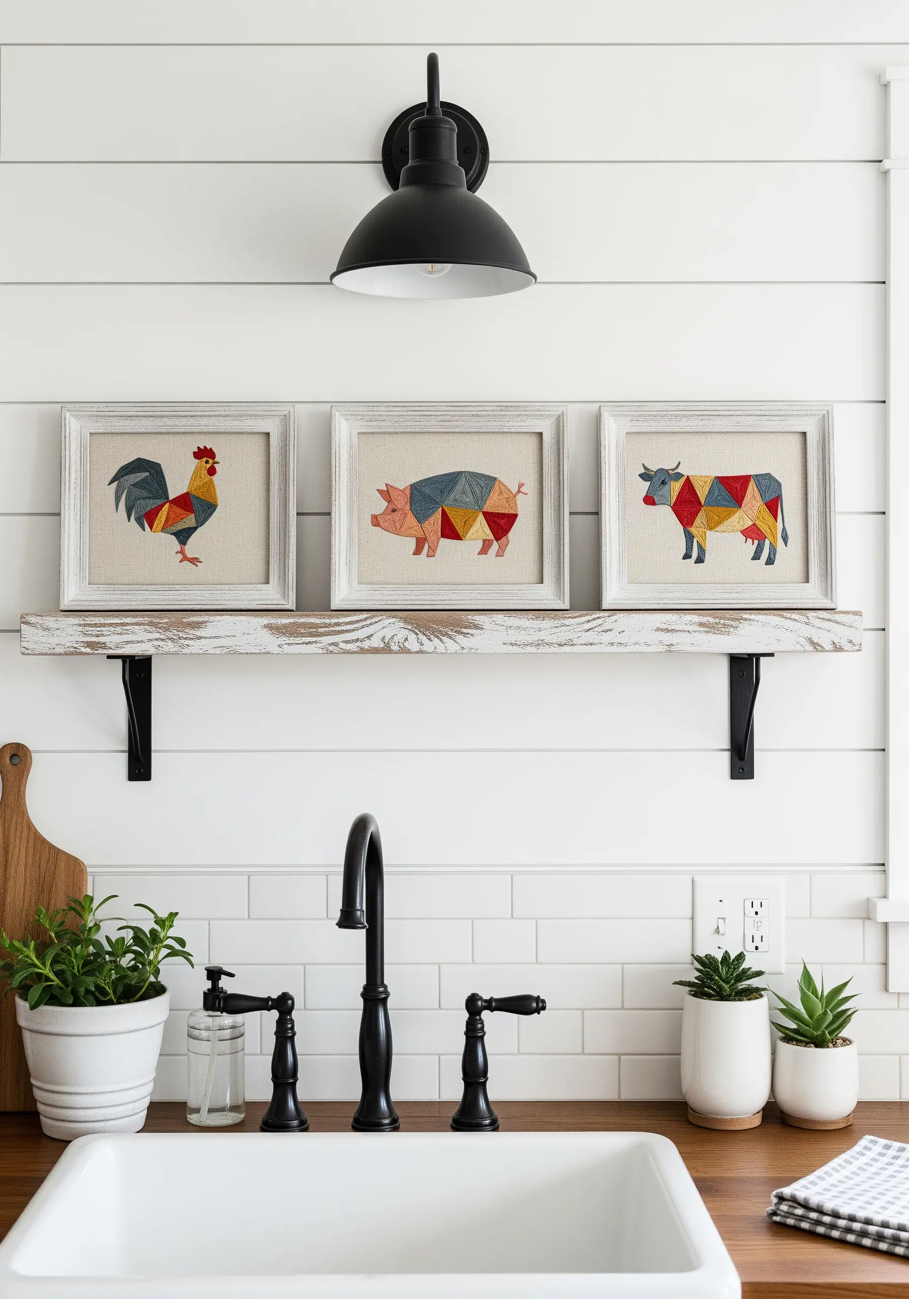 A trio of framed embroideries featuring a rooster, pig, and cow made of colorful geometric shapes.