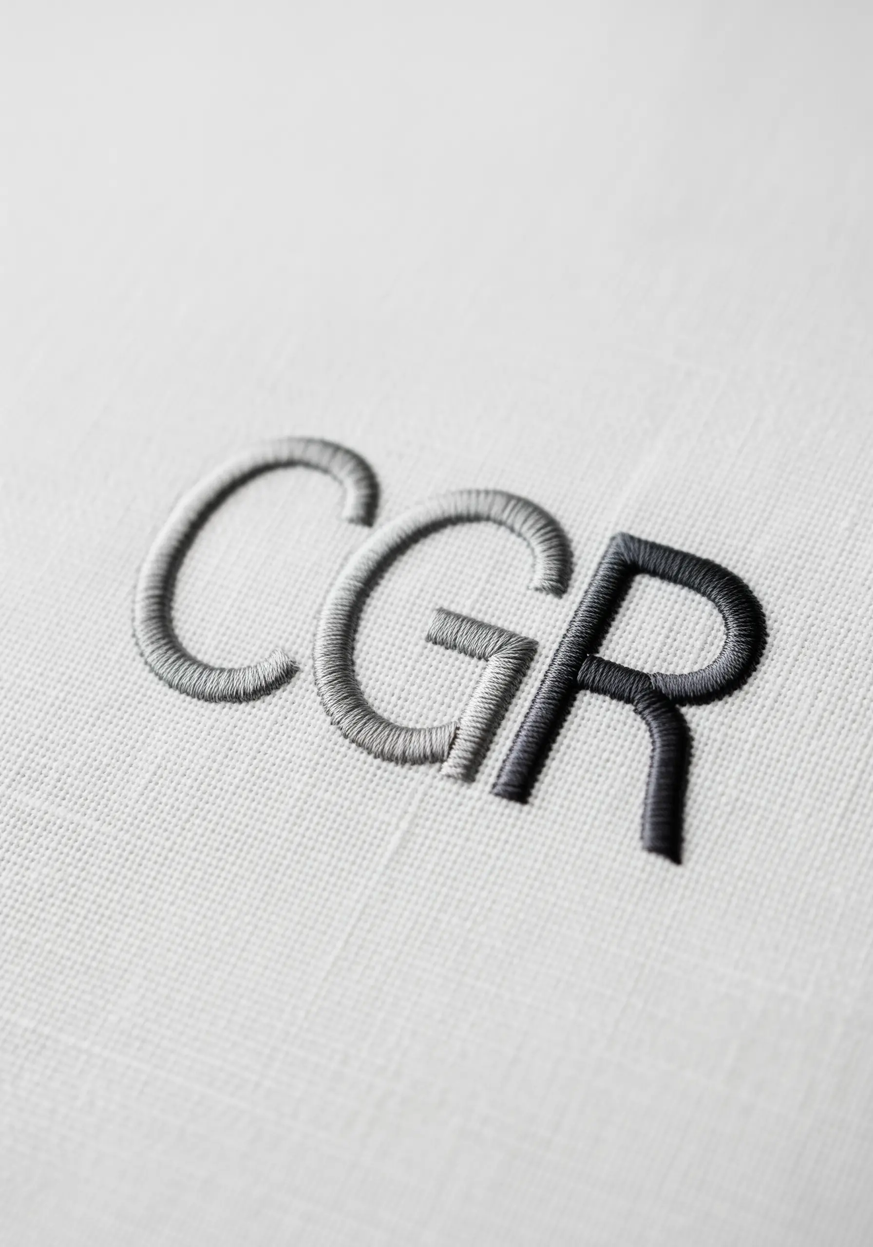 Initials 'CGR' with a smooth grey-to-black gradient satin stitch.