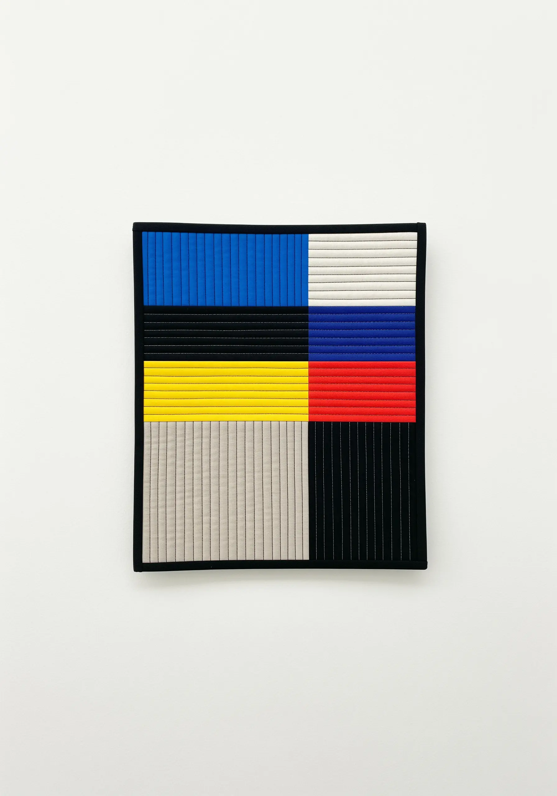 A minimalist, color-blocked textile artwork made of precisely stitched vertical pleats.