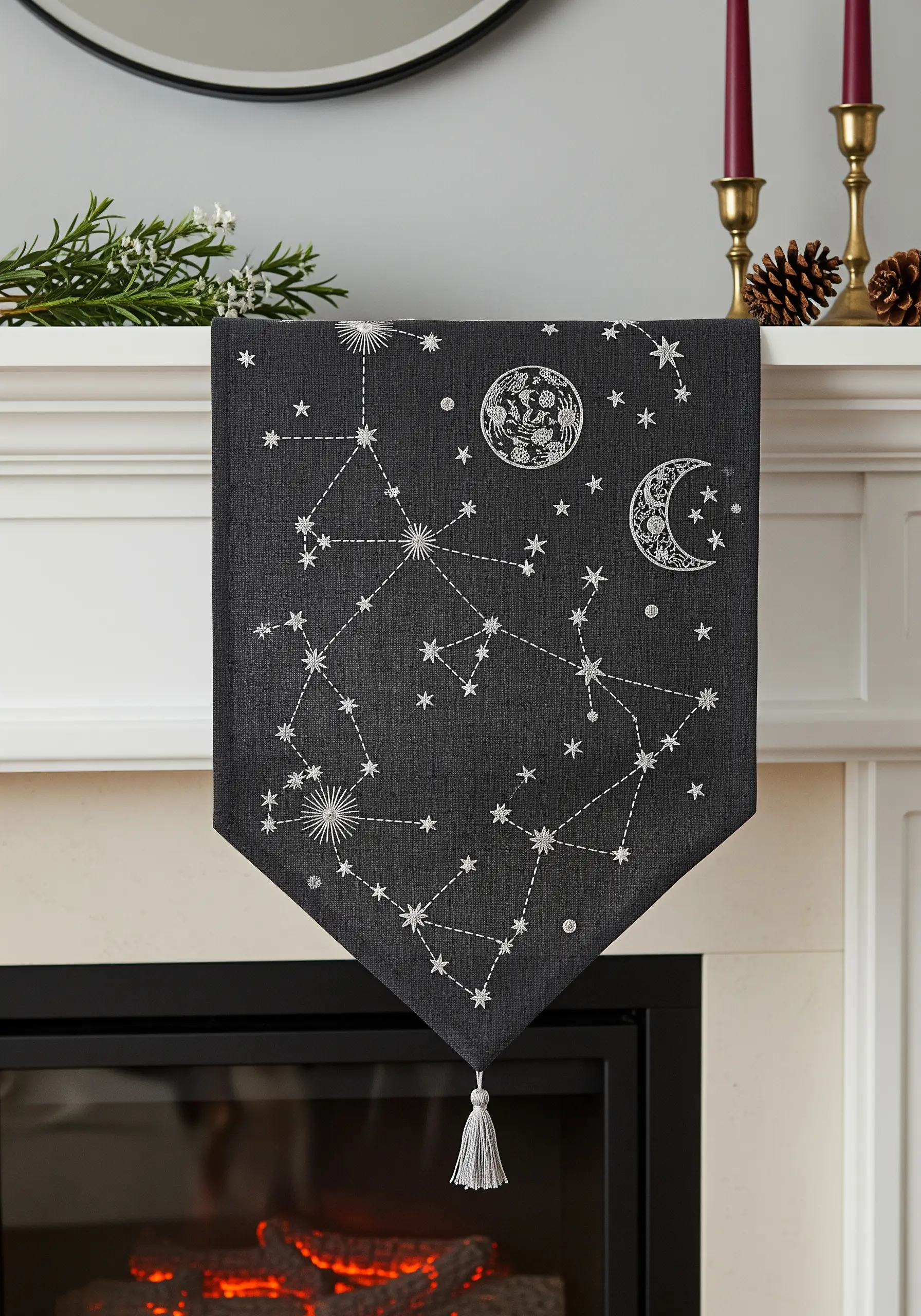 A dark grey mantel runner embroidered with white celestial constellations and moons.