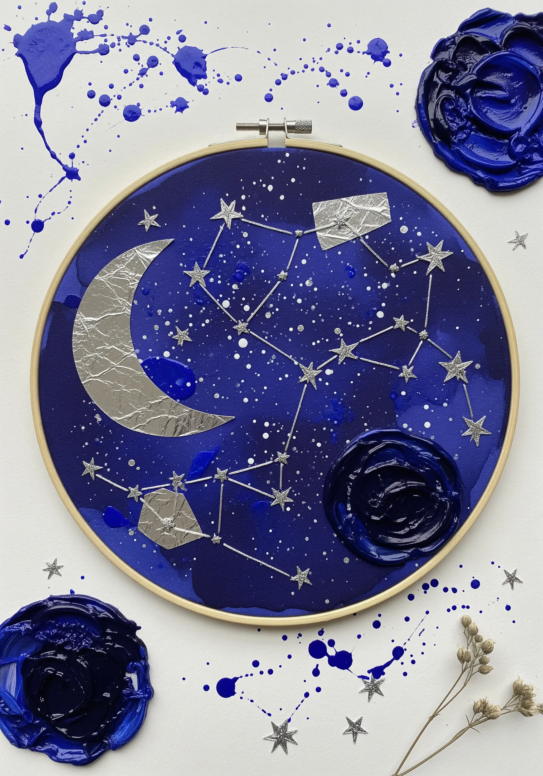 Embroidered constellation on a painted blue hoop with a silver foil moon and wax seals.