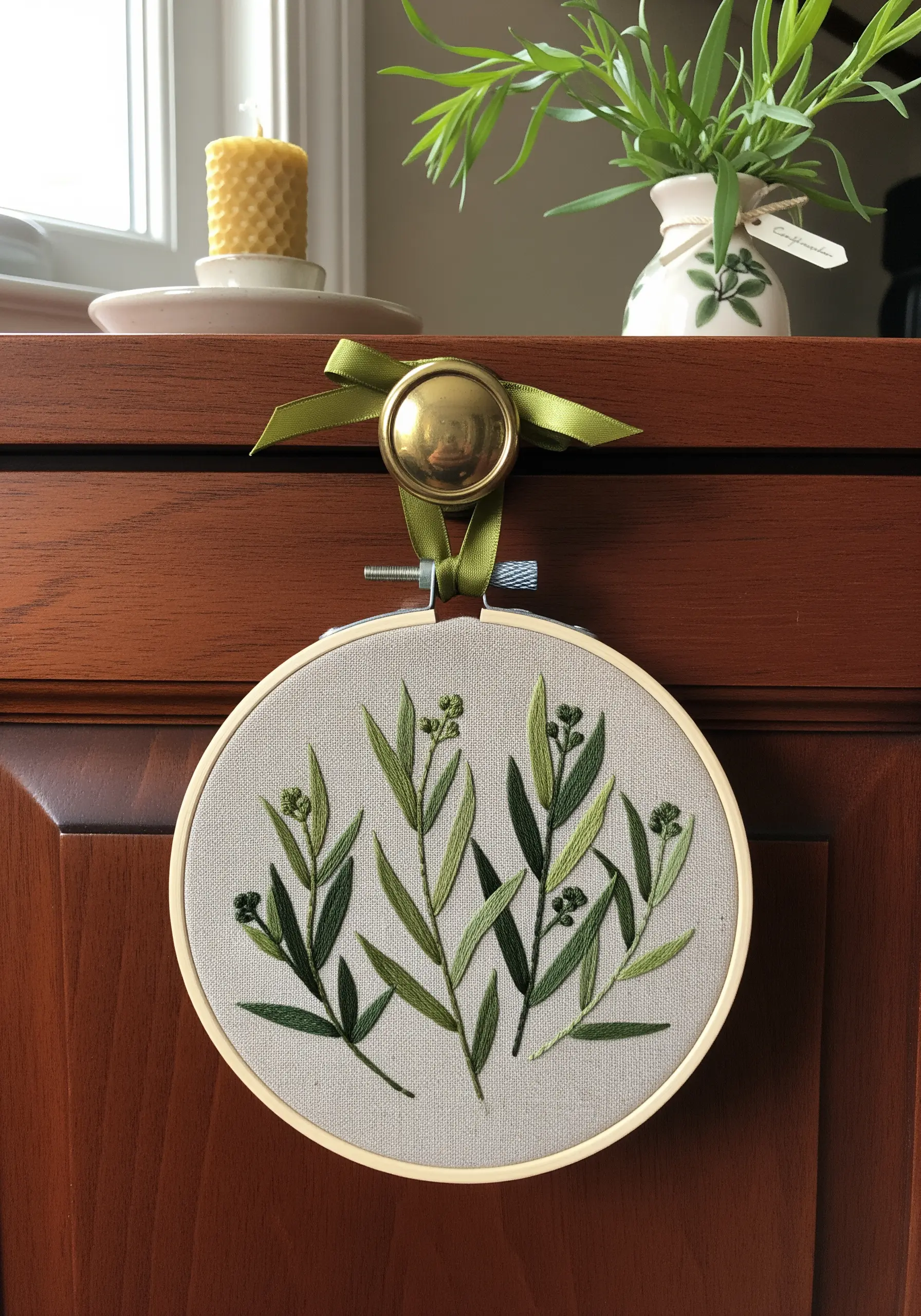 A collection of tarragon stems embroidered in various shades of green to create depth.