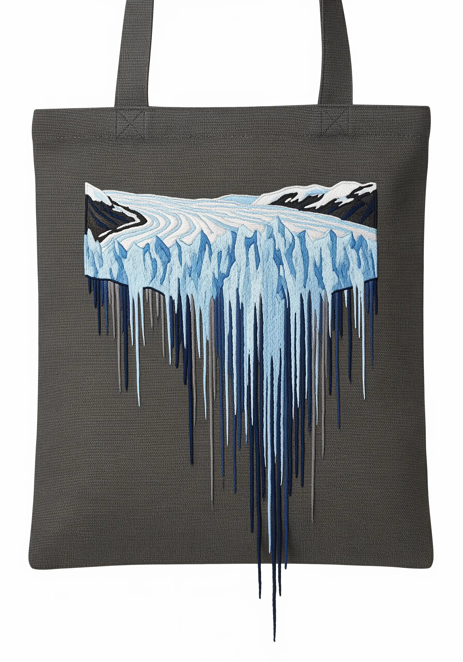 An embroidered glacier with long, loose threads dripping down a dark gray tote bag.