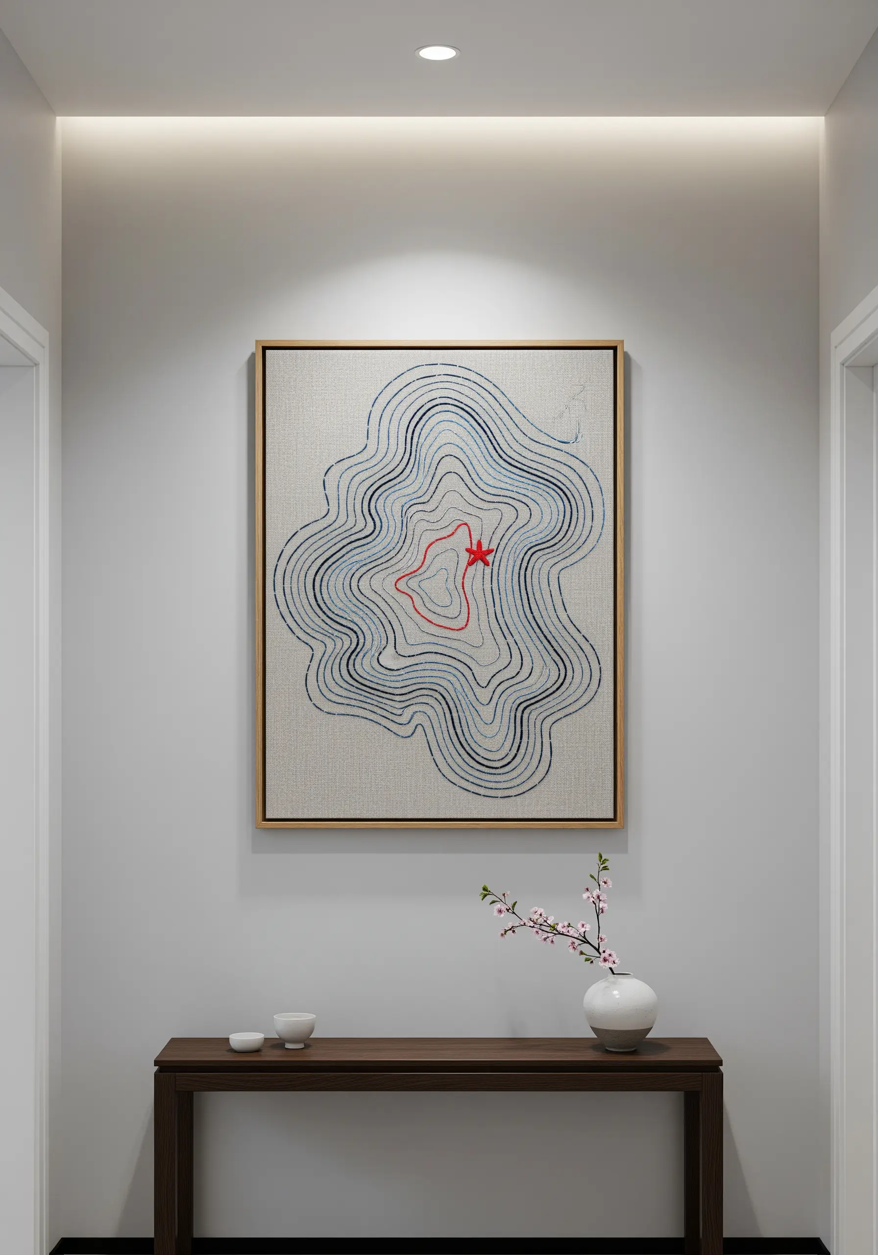 An abstract embroidery of blue and grey contour lines with a single, small red star at the center.