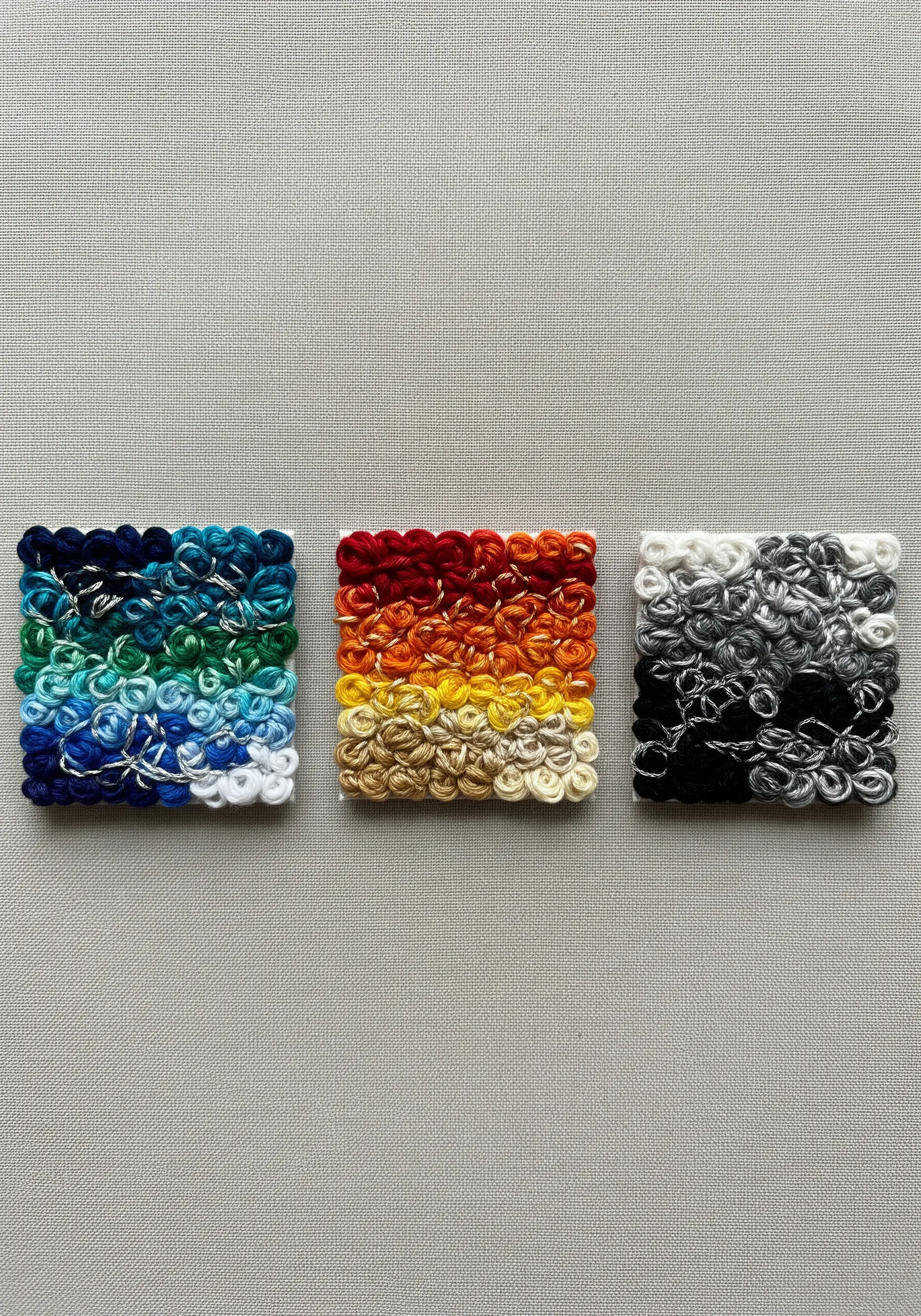Three small squares filled with dense French knots in blue, red-orange, and black-and-white gradients