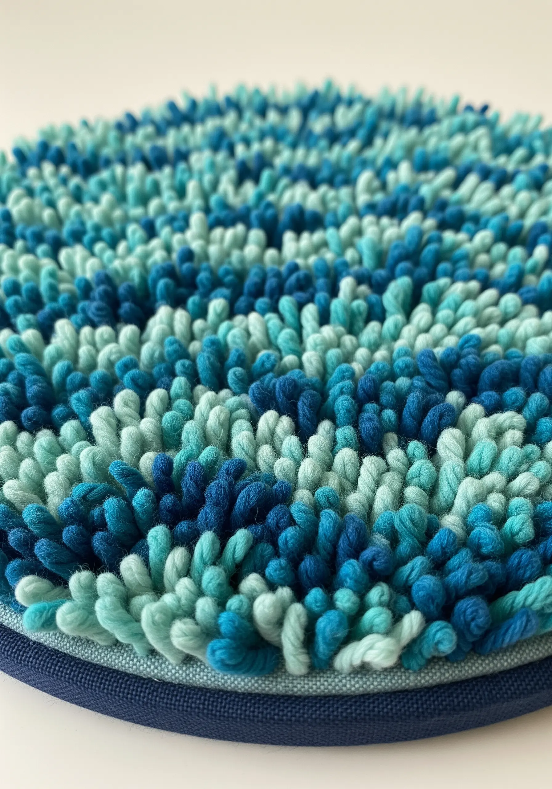 Dense blue and turquoise Turkey work creating a plush, rug-like texture.
