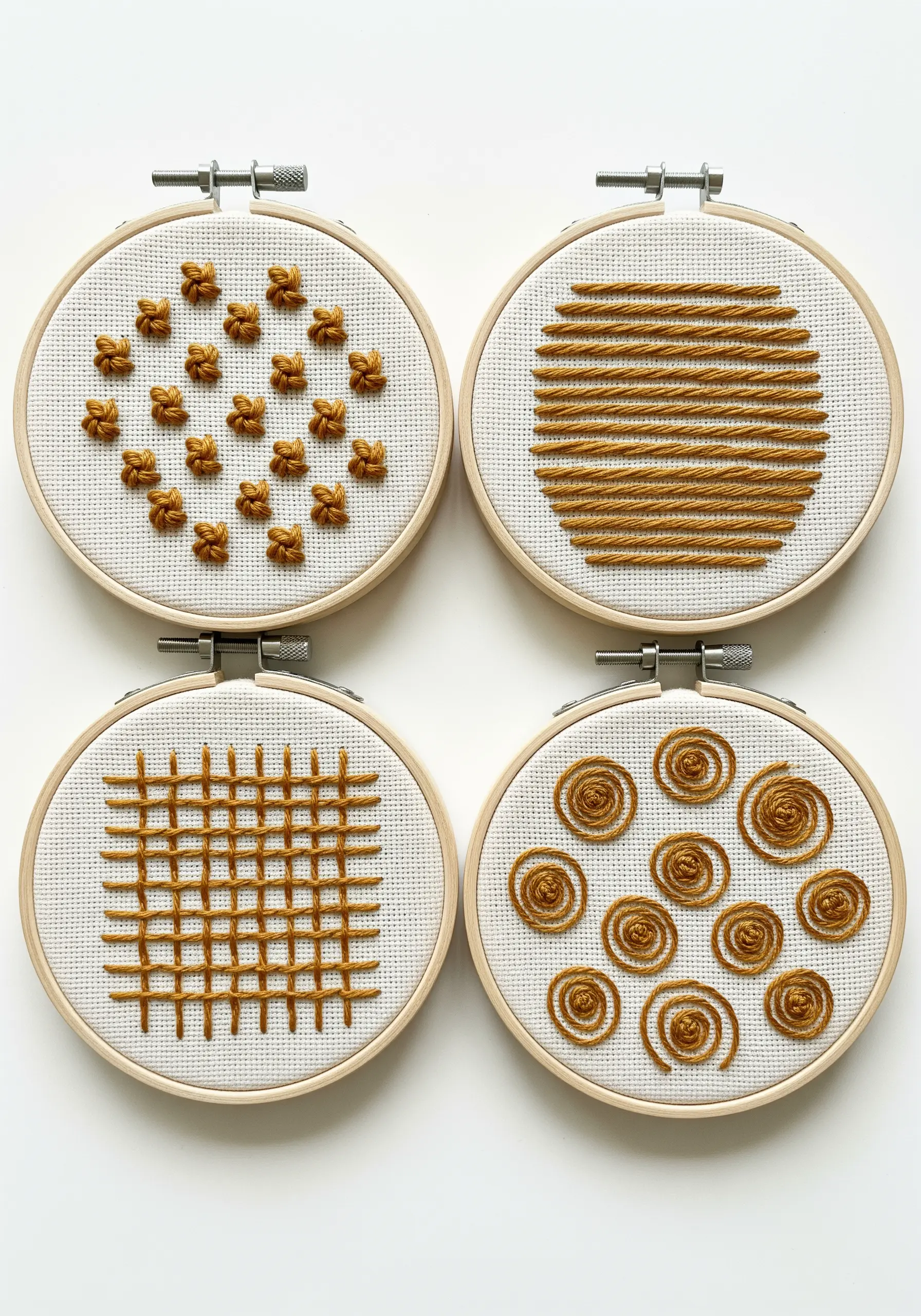 Four mini embroidery hoops, each showcasing a different textural stitch in gold thread.