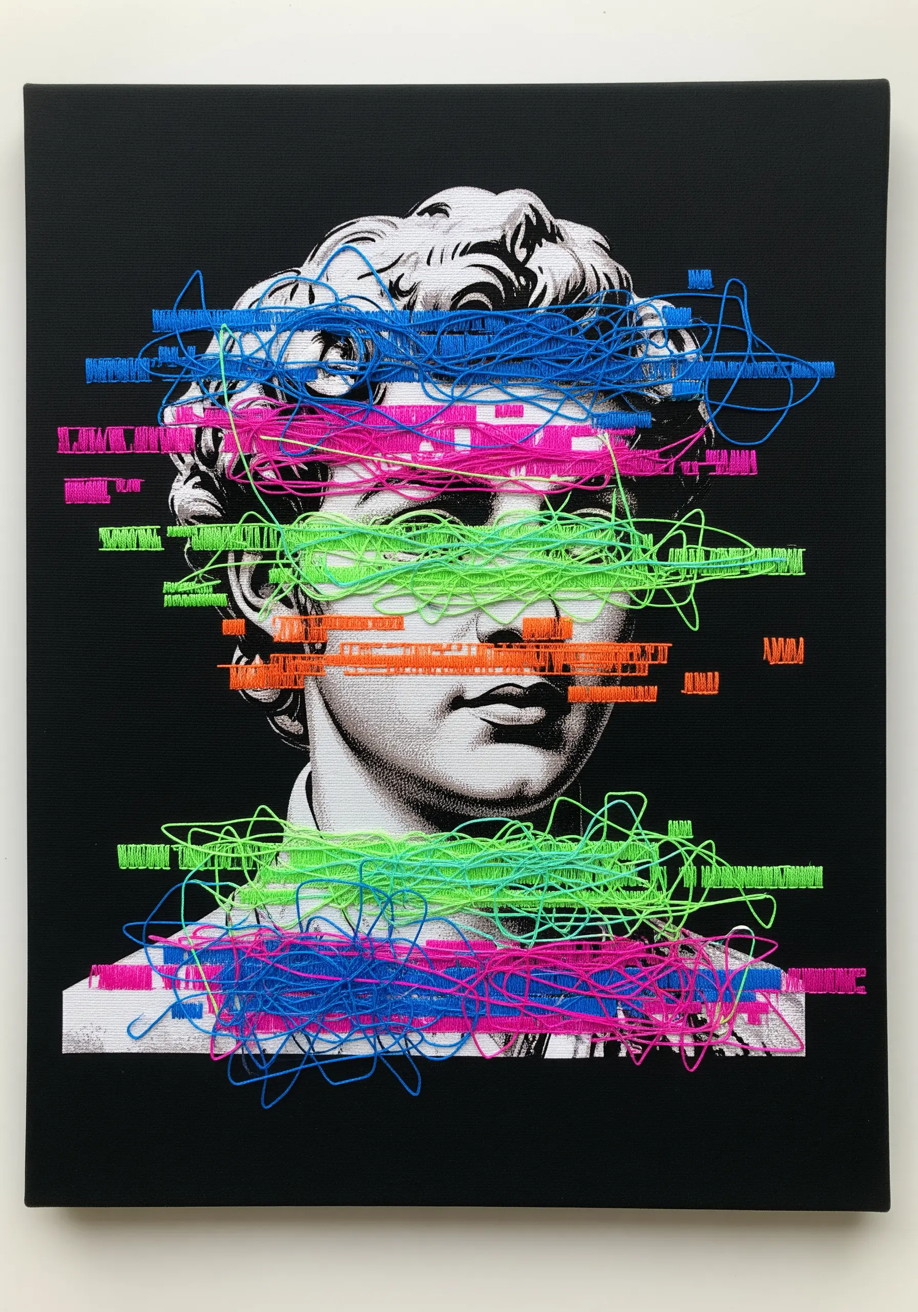 A classical bust printed on canvas, overlaid with neon pink, green, and blue glitch-style embroidery.
