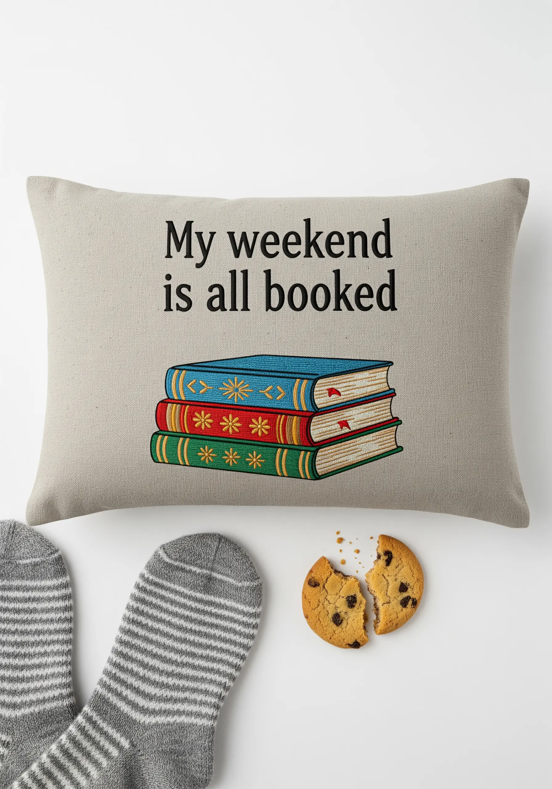 Embroidered stack of books with clean backstitch outlines and satin stitch color blocks.