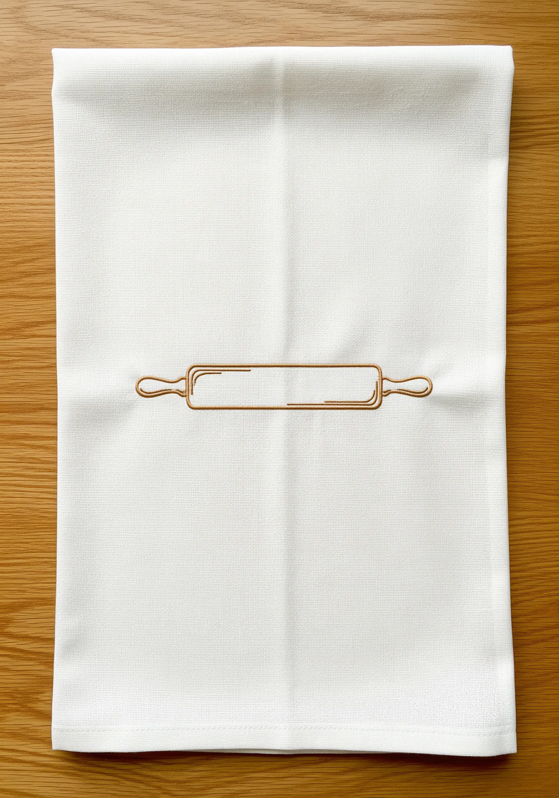 A minimalist line art embroidery of a rolling pin on a white cotton kitchen towel.