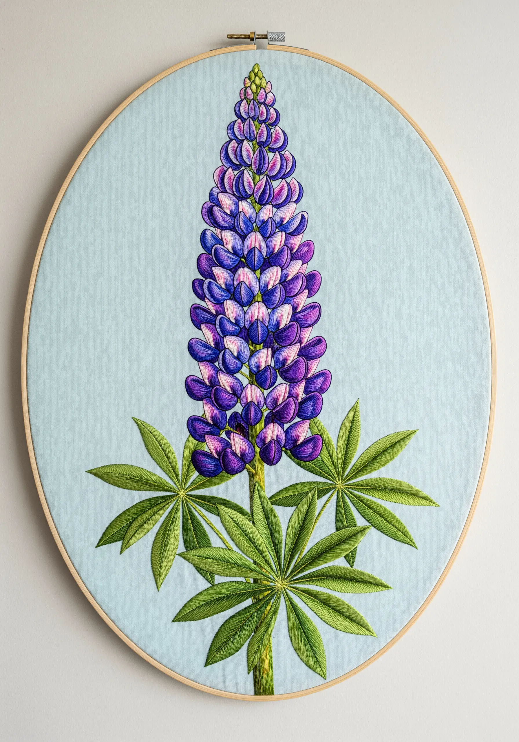 Detailed lupine stalk embroidery with purple, blue, and white satin-stitched florets on blue fabric.