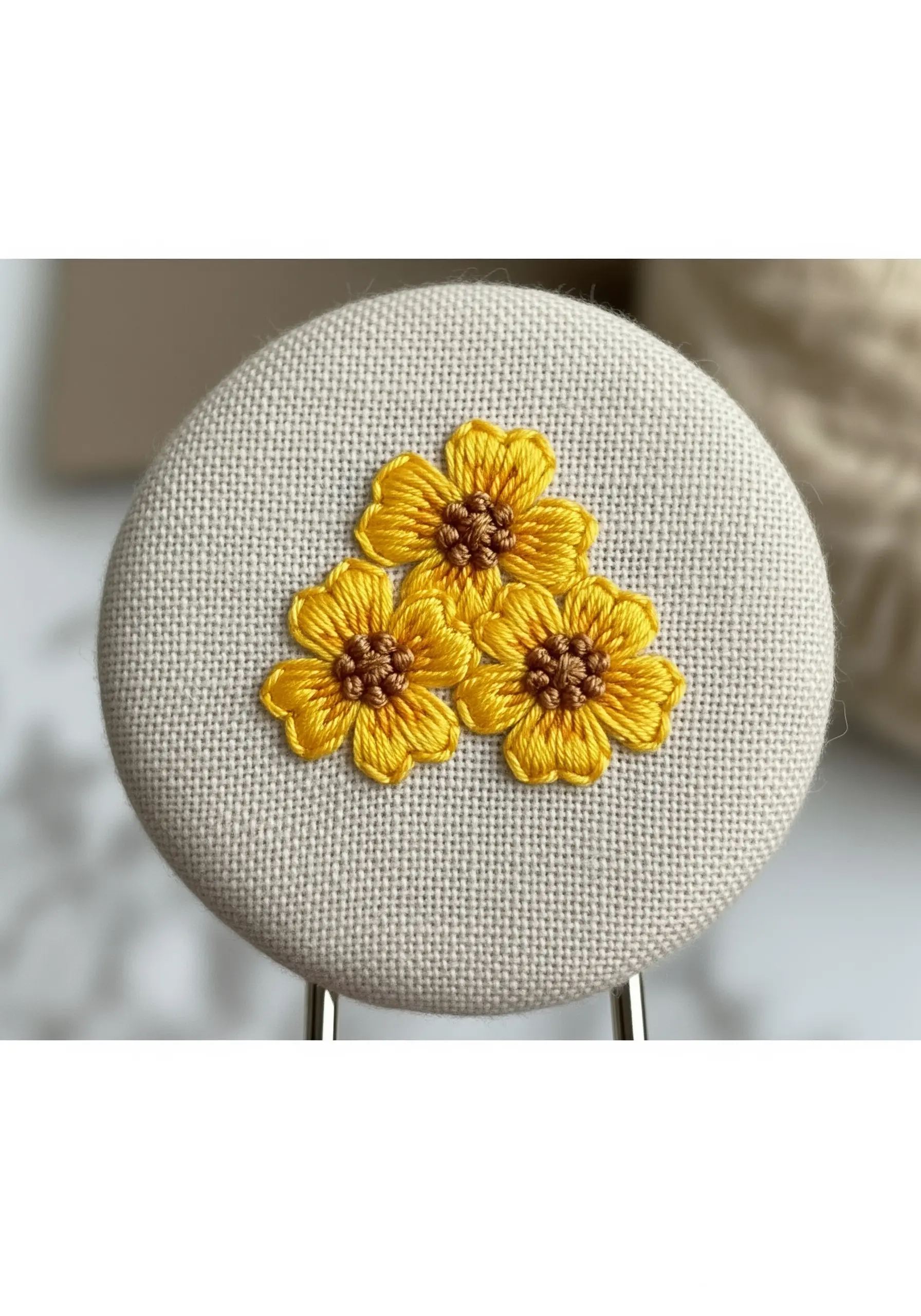 A cluster of three small yellow flowers with delicate outlines and brown centers.