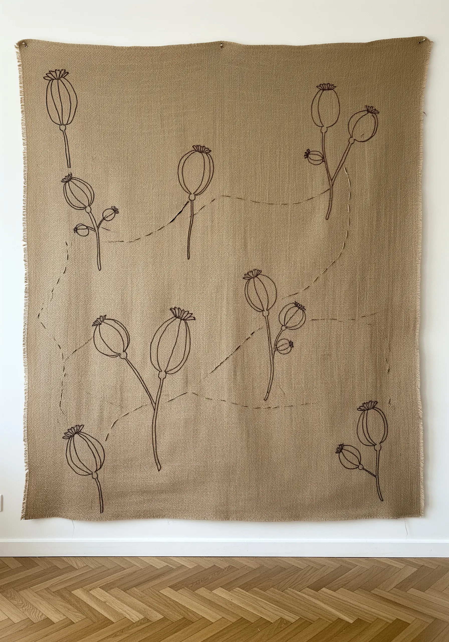 A large burlap wall hanging featuring delicate line drawings of poppy seed pods.