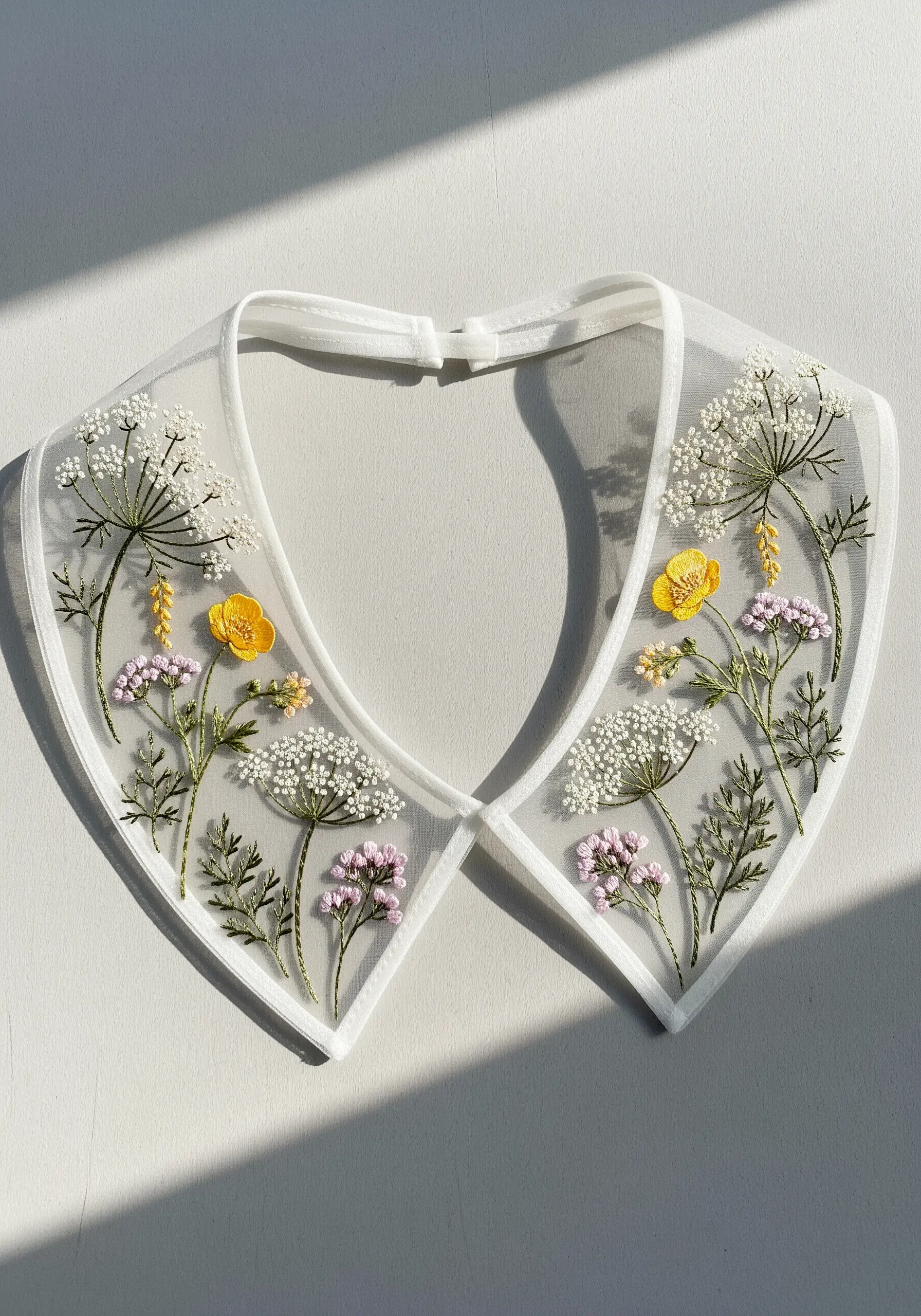 Wildflowers including Queen Anne's Lace embroidered on a detachable, sheer organza collar.
