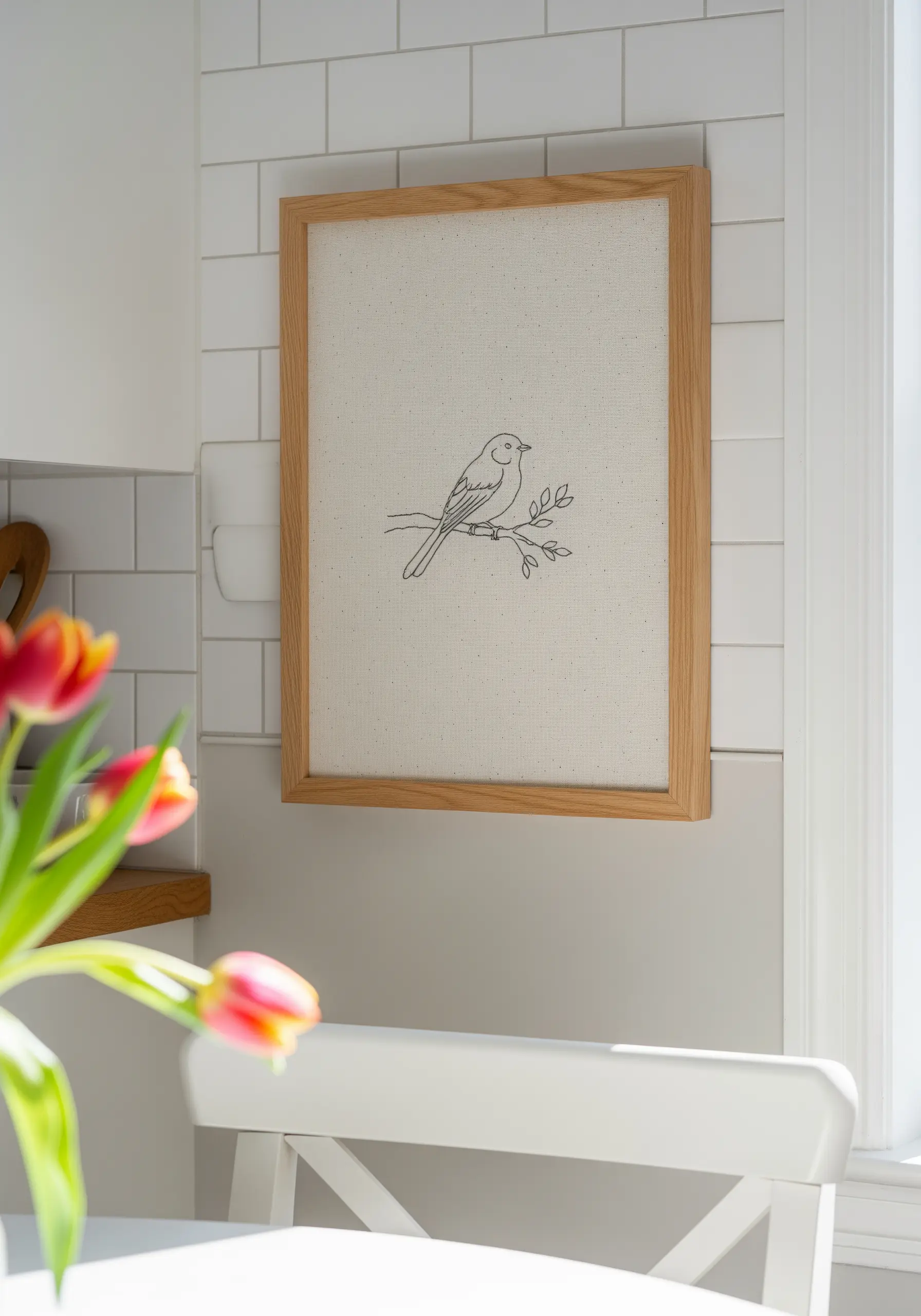 Minimalist bird line drawing embroidered on oatmeal canvas