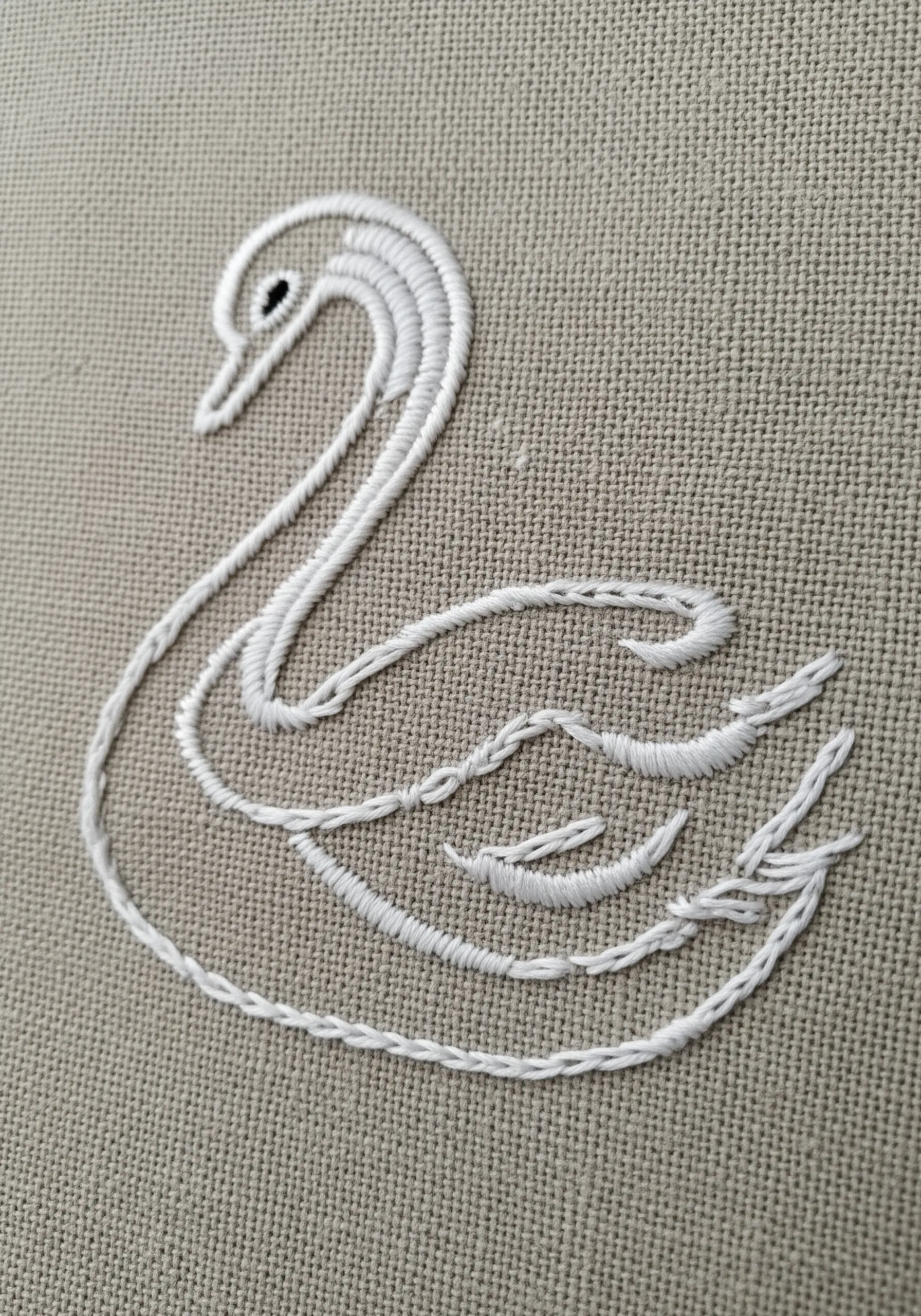 White swan embroidery using thick chain stitches for the outline