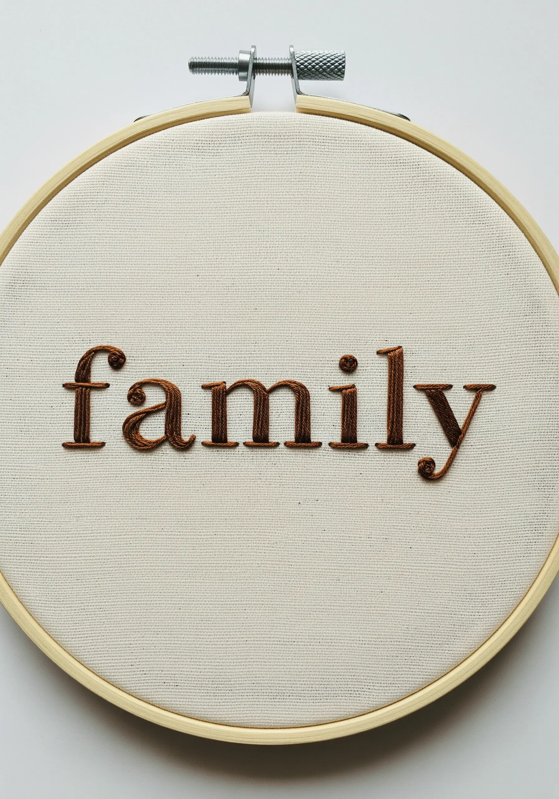 The word 'family' in a brown satin-stitched serif font.
