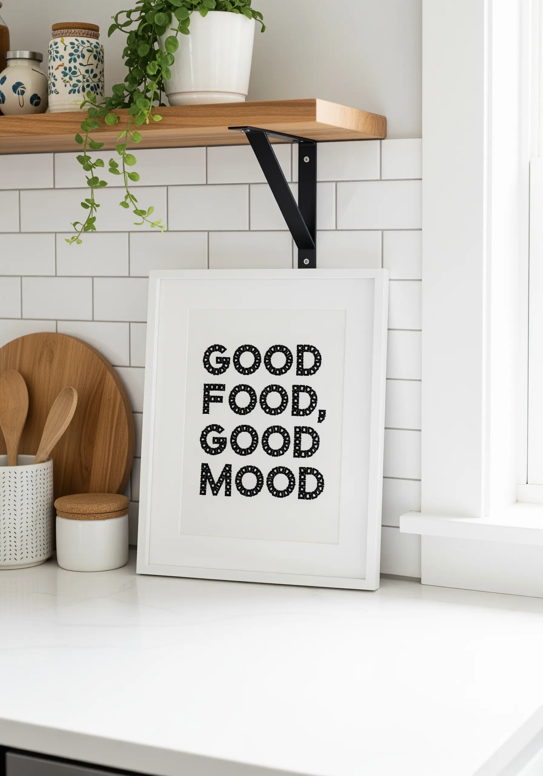 Framed embroidery of the text 'Good Food, Good Mood' with patterned fills inside each letter.