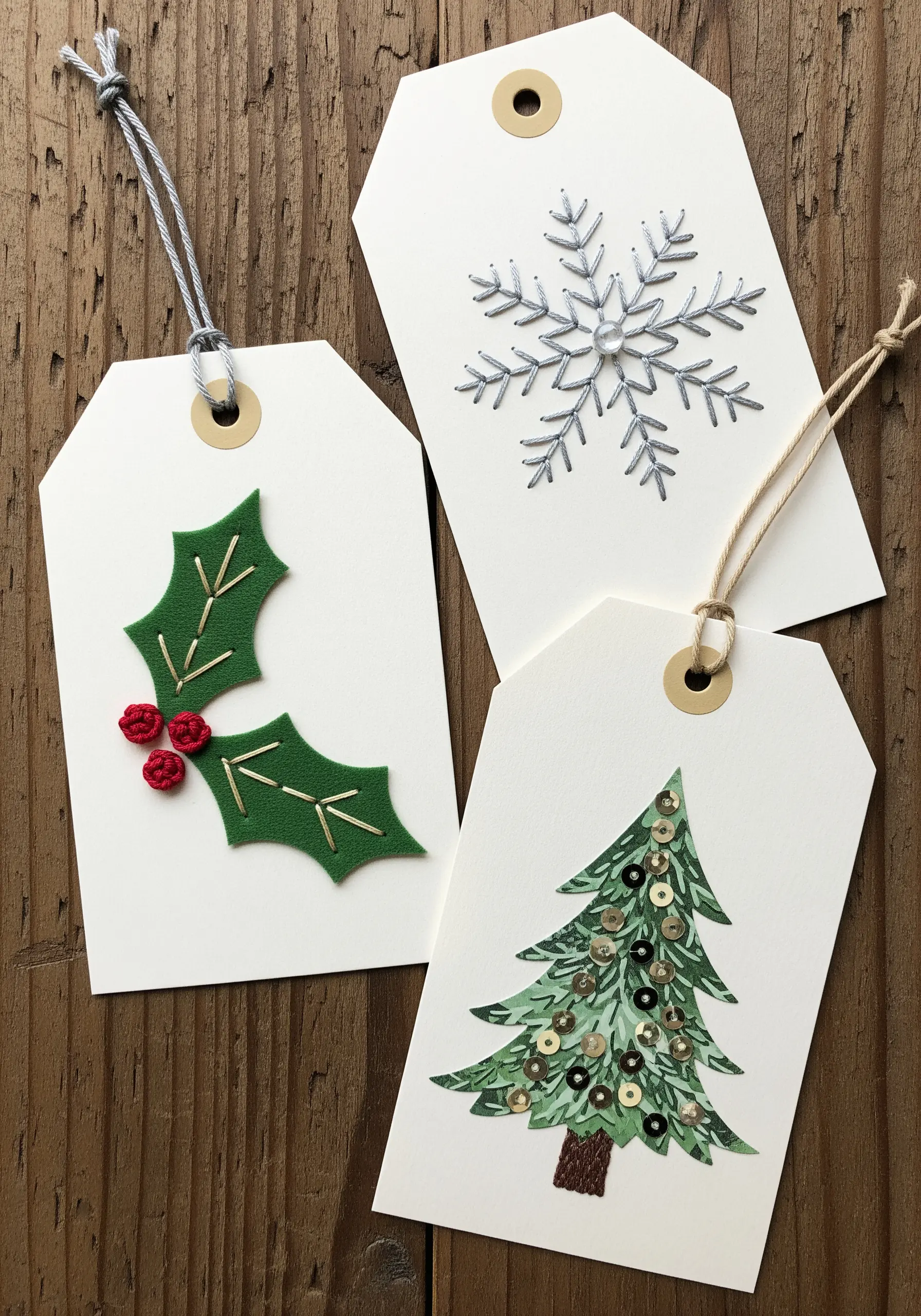 Three handmade Christmas gift tags decorated with felt appliqué, sequins, and metallic thread.