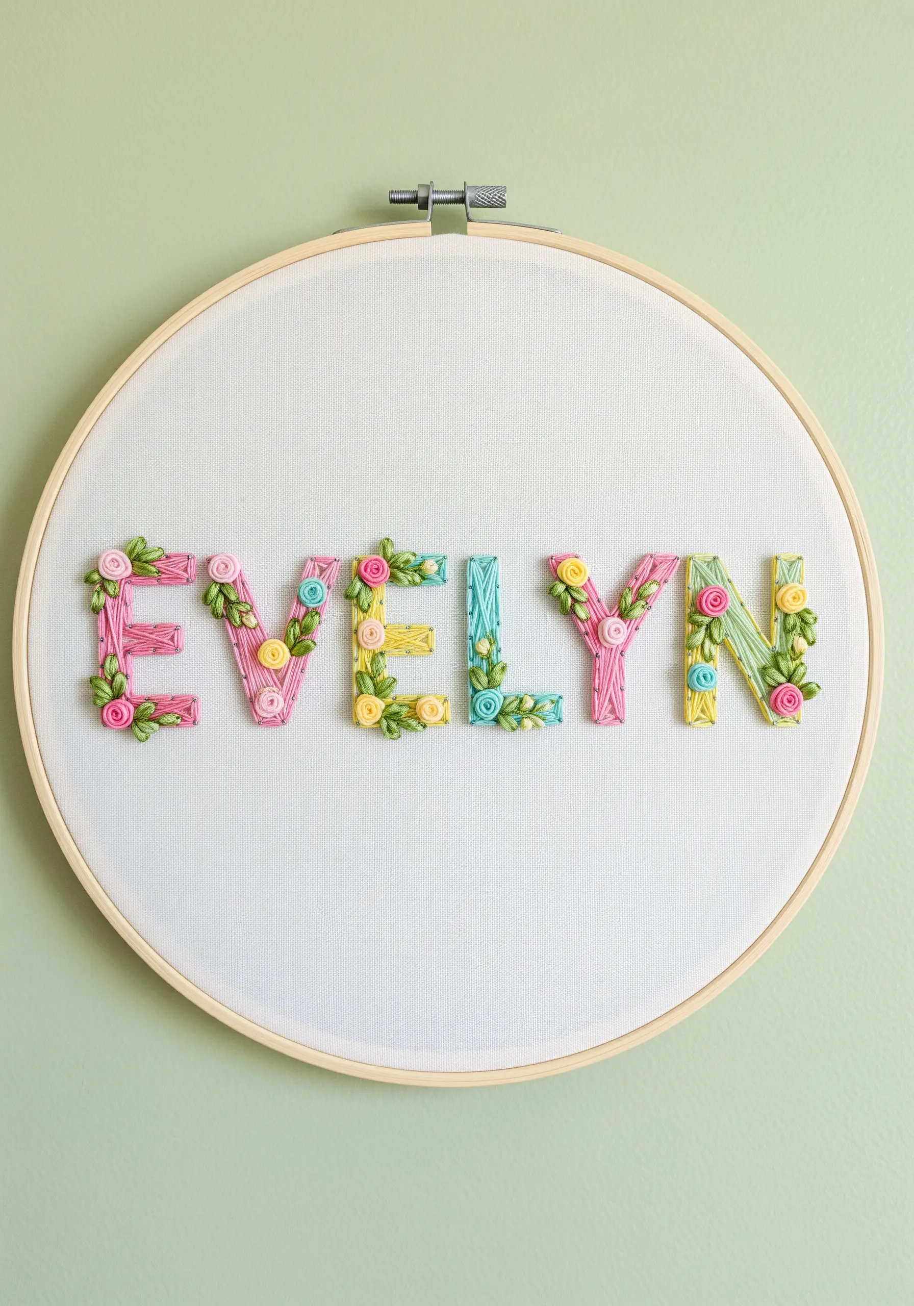 Pastel letters adorned with tiny, 3D roses made from silk ribbon embroidery.
