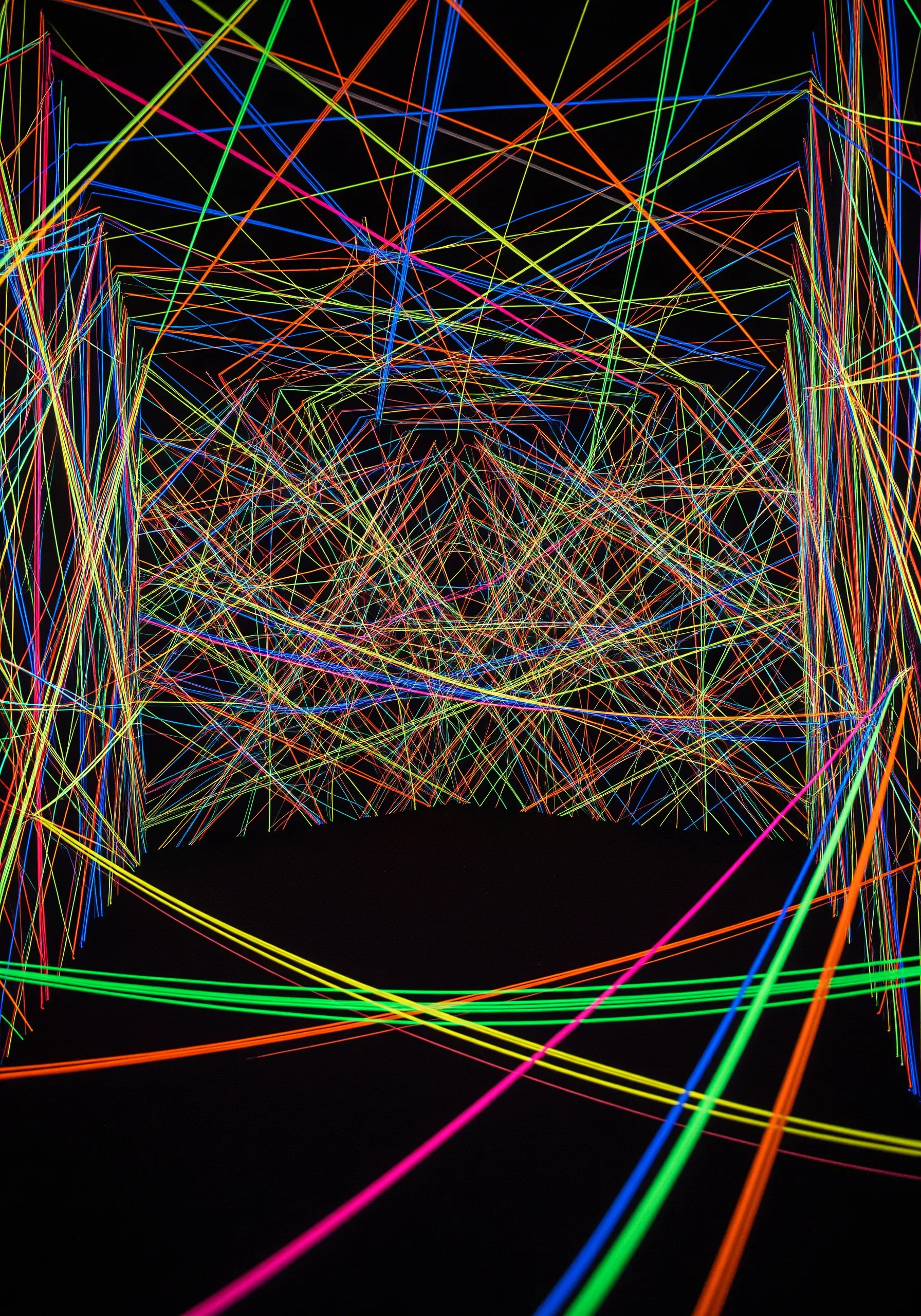 A chaotic, energetic mix of overlapping stitches in bright, clashing colors.