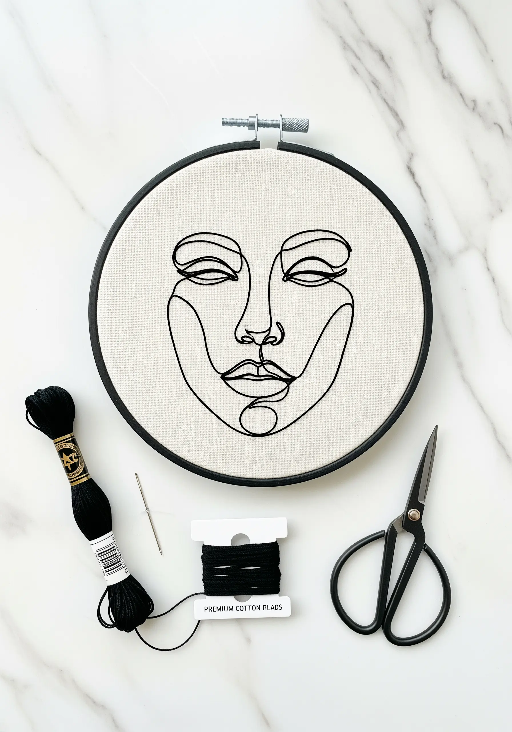 A minimal line art portrait of a face stitched in bold black thread on off-white canvas.