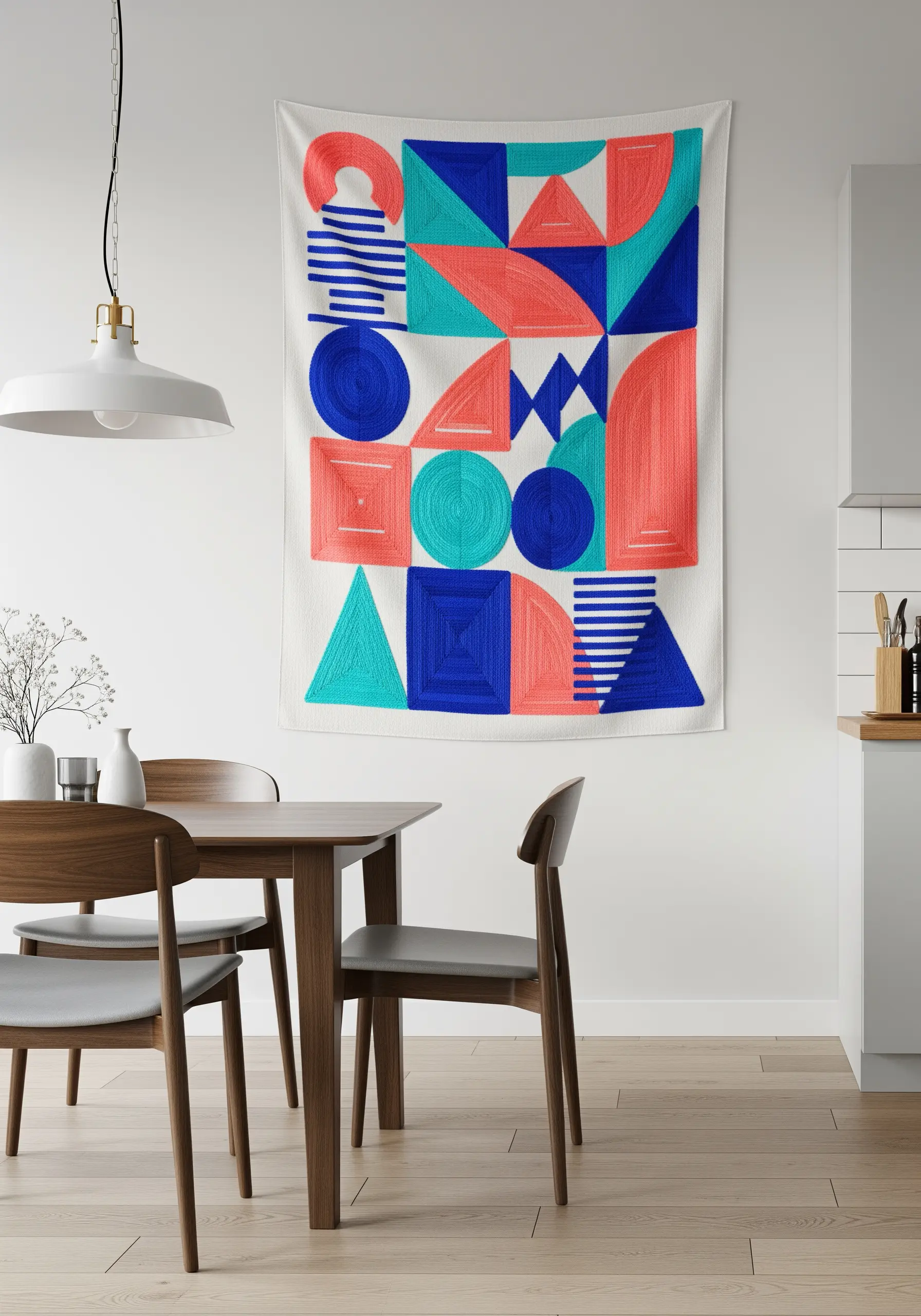 A large embroidered tapestry with abstract geometric shapes in blue, teal, and coral.