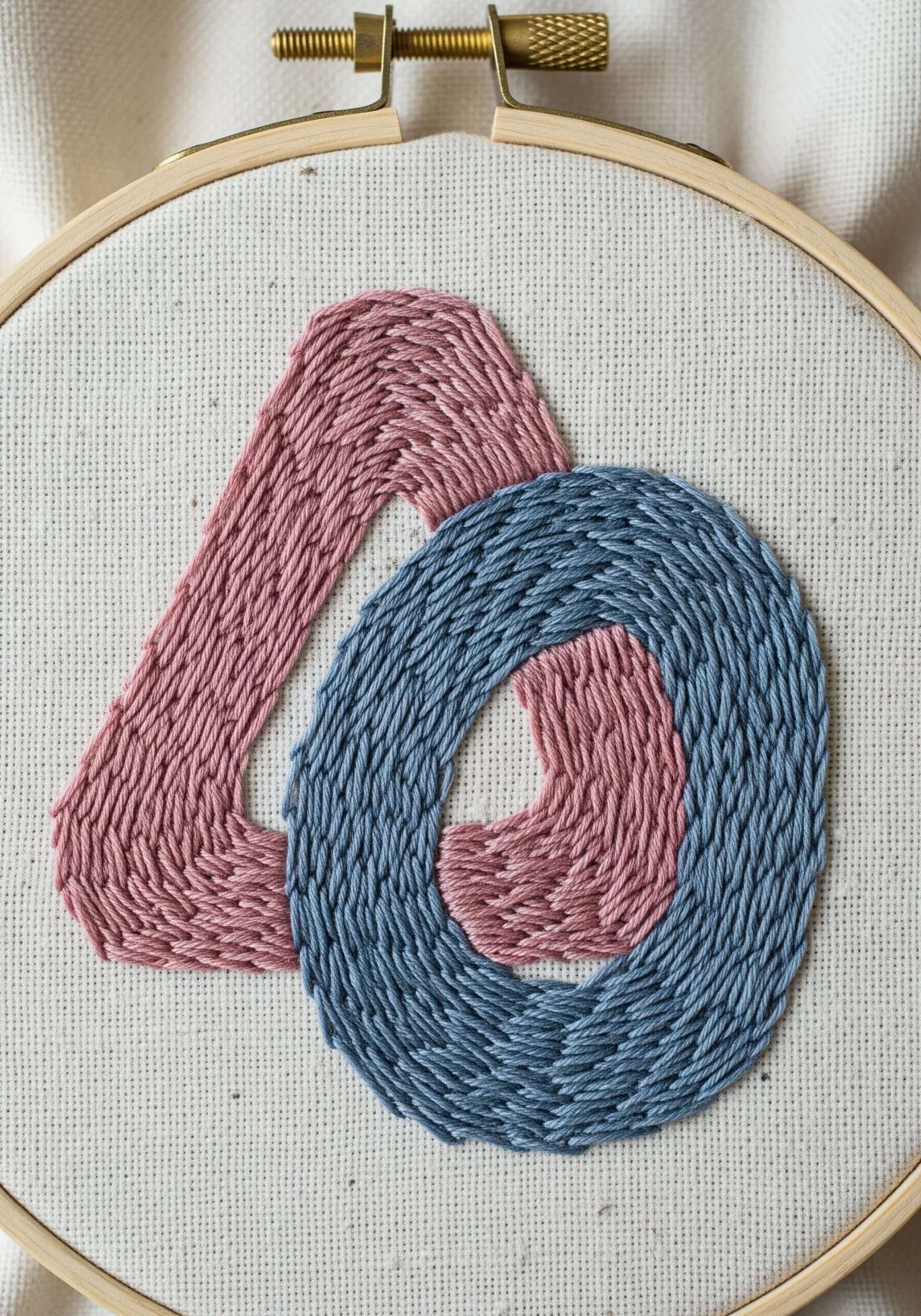 The number 40 embroidered with contoured fill stitches in pink and blue.