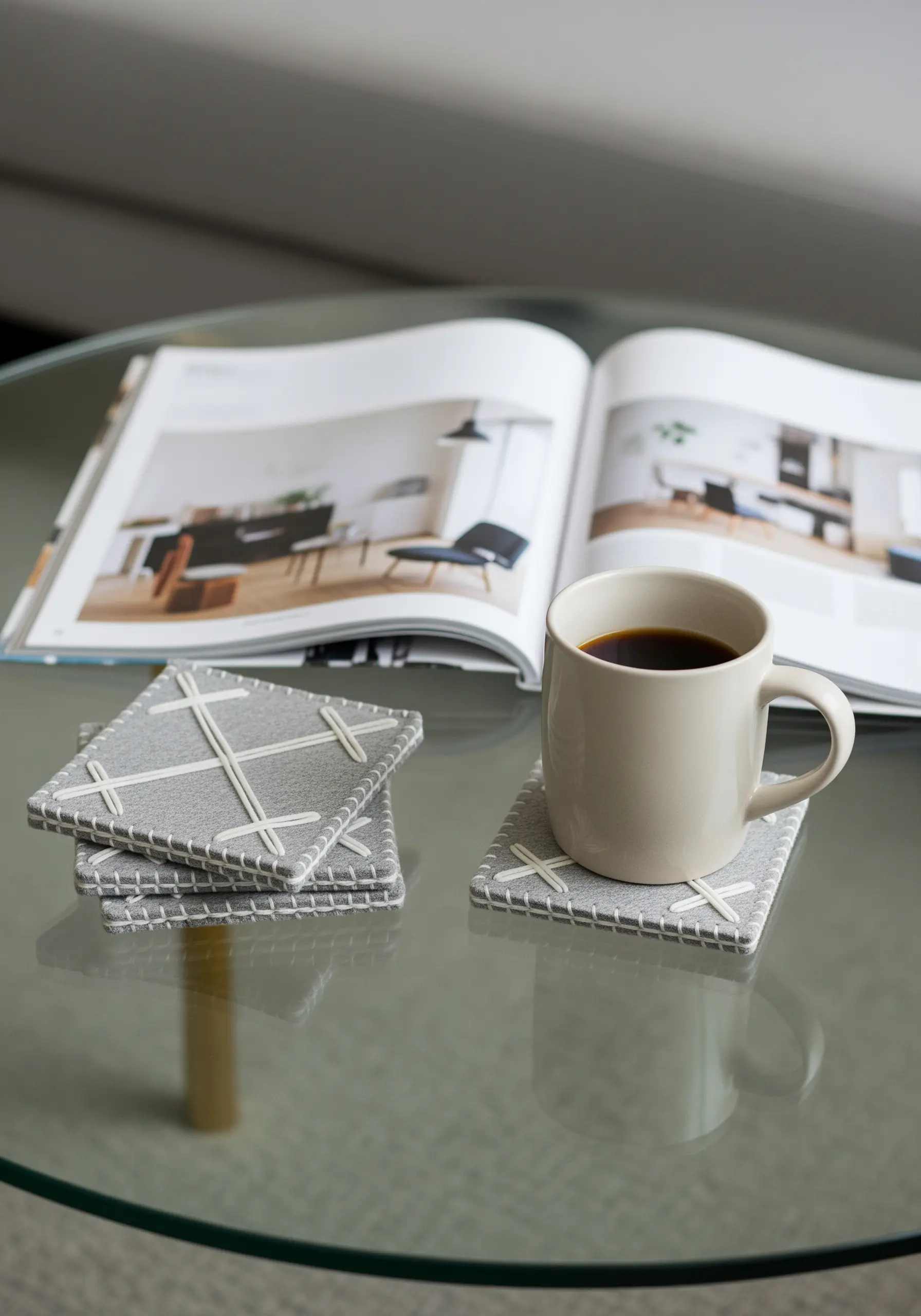 Grey felt drink coasters with white geometric stitching