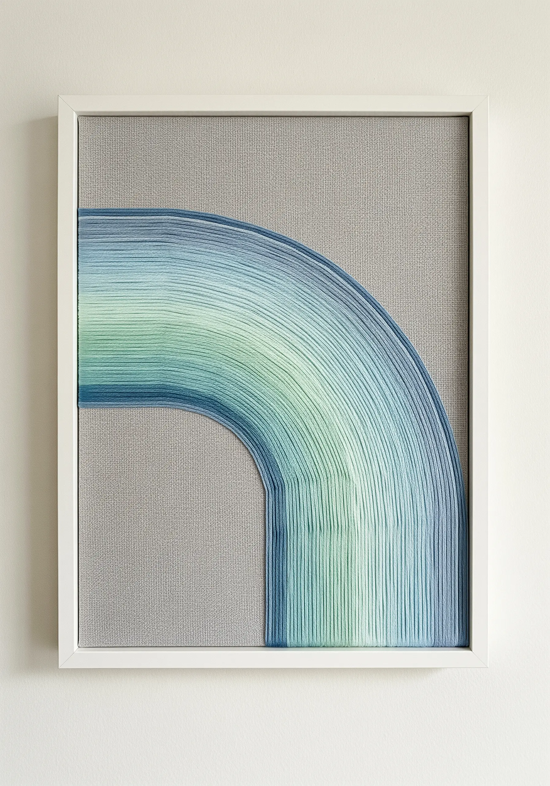 An abstract curved shape filled with a smooth, linear stitch gradient from blue to green.