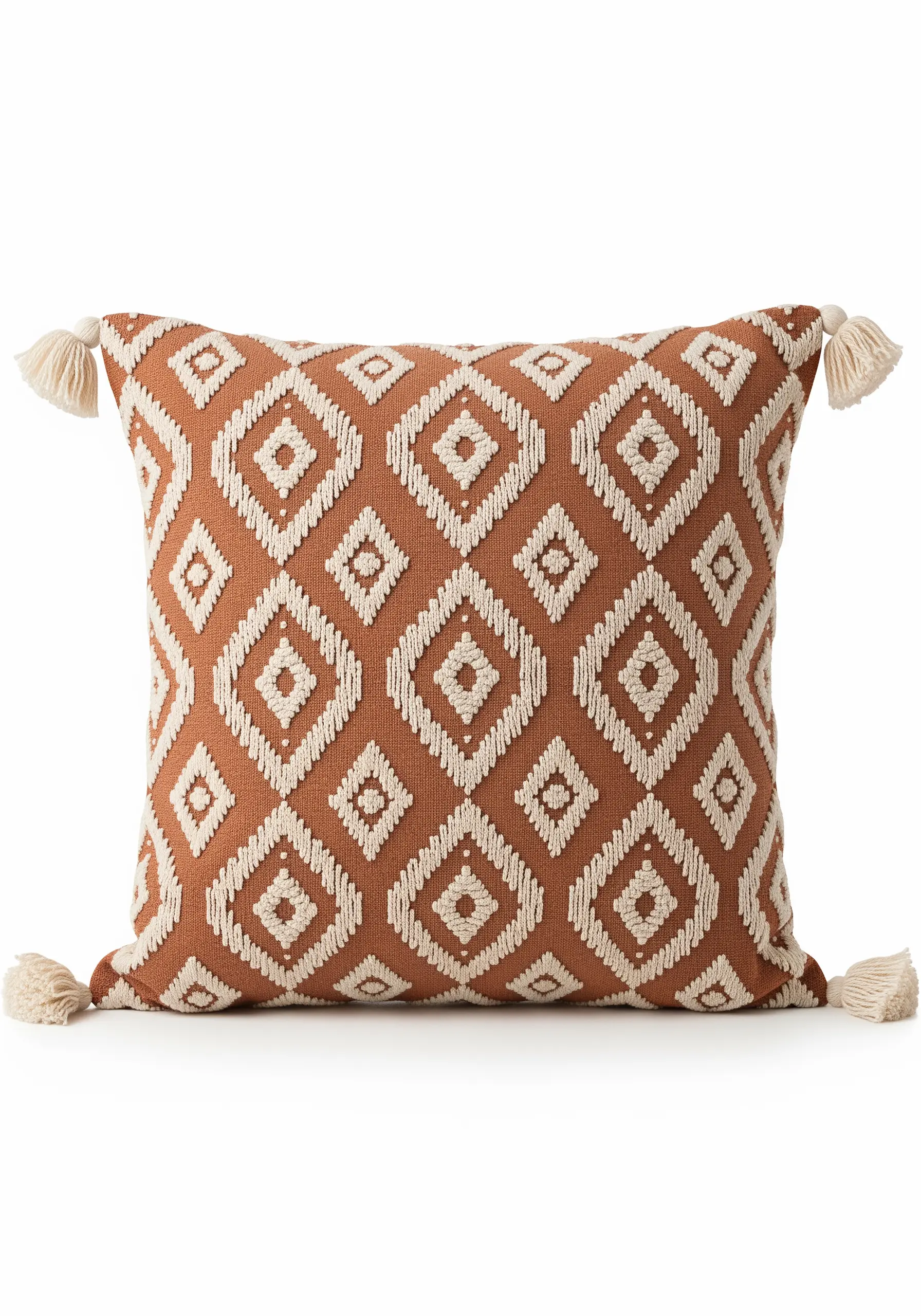 A rust-colored pillow with an all-over geometric diamond pattern in raised white embroidery.