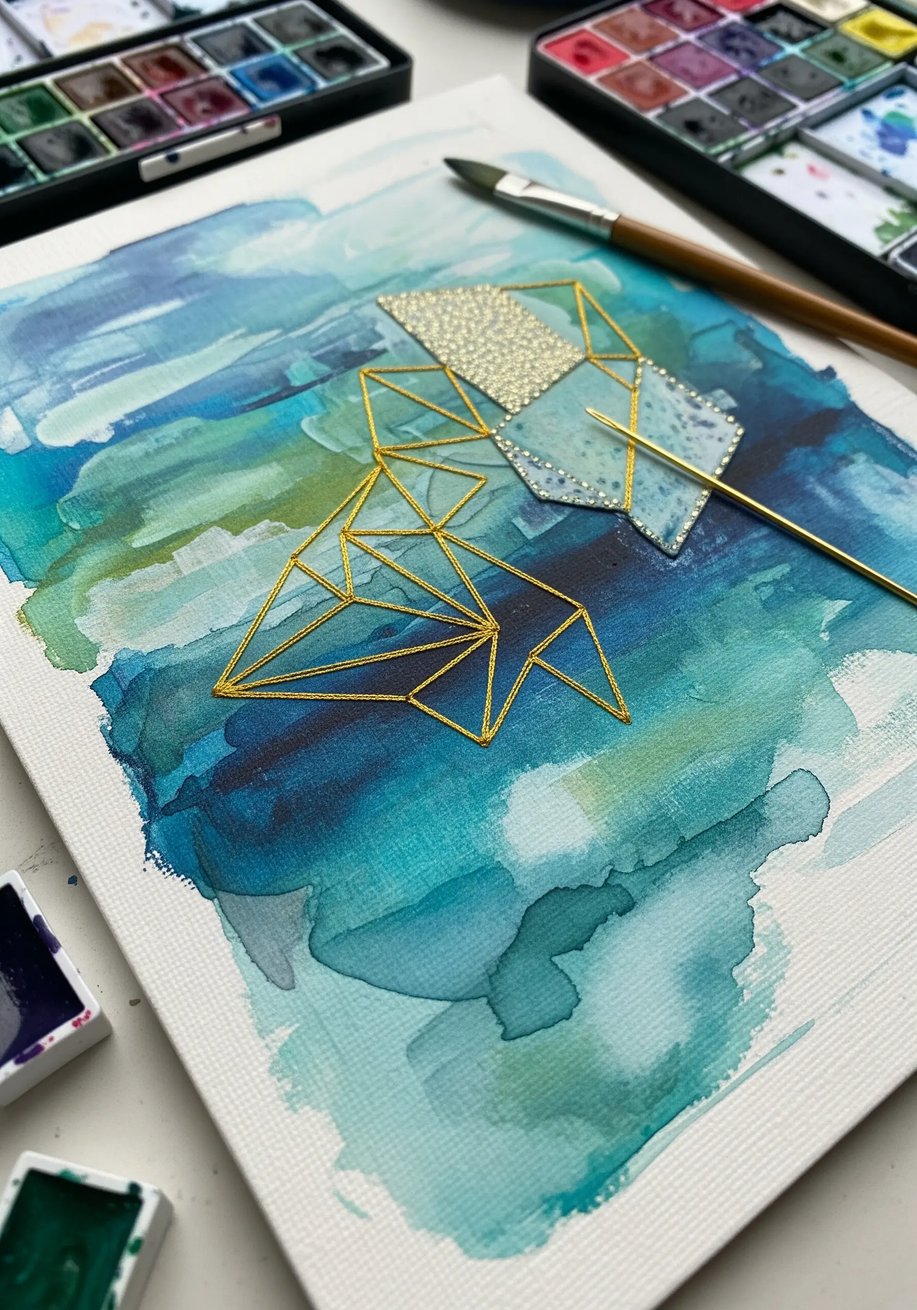 Gold metallic thread embroidery on blue watercolor paper art