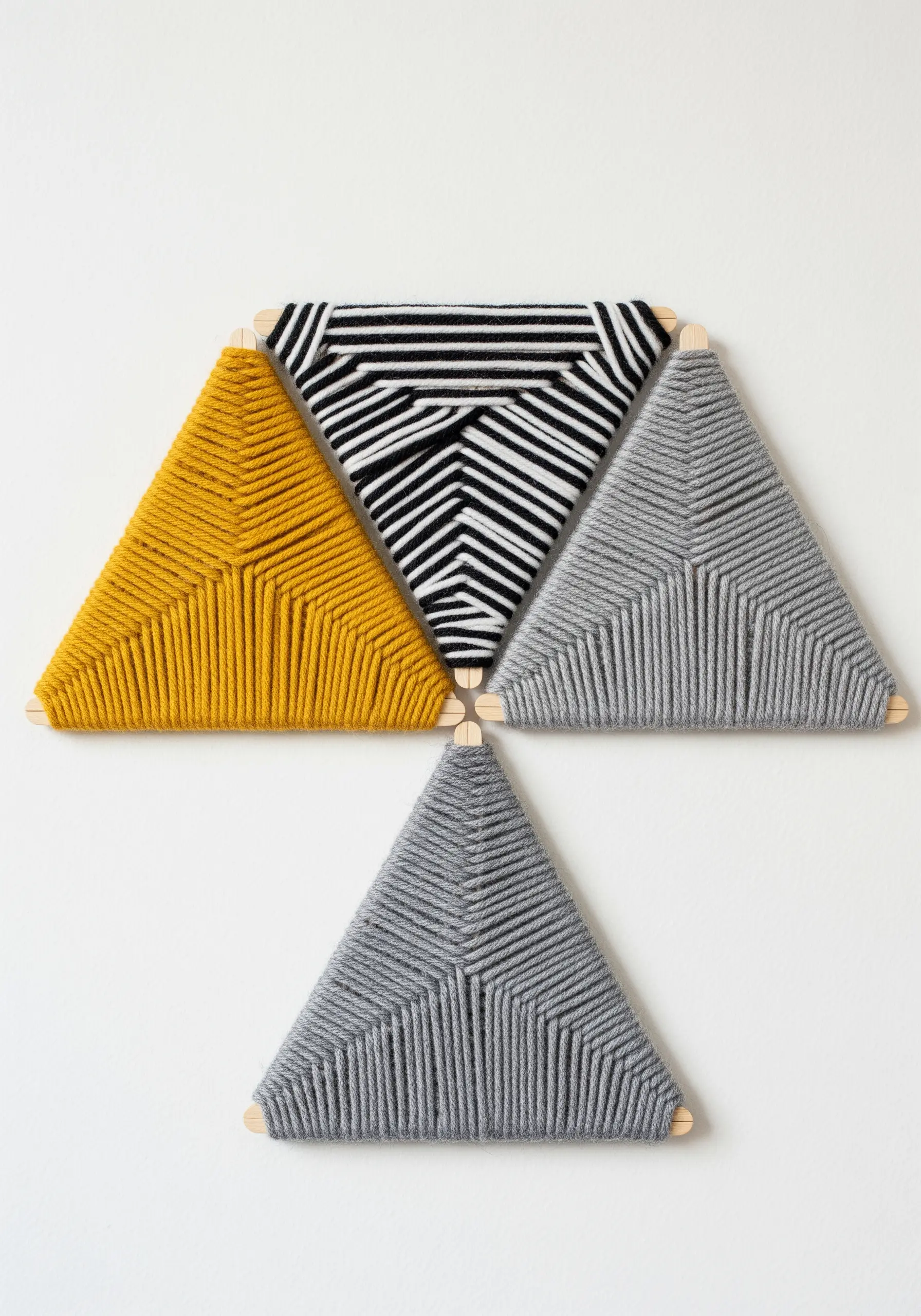 Three triangle stick weavings with geometric patterns