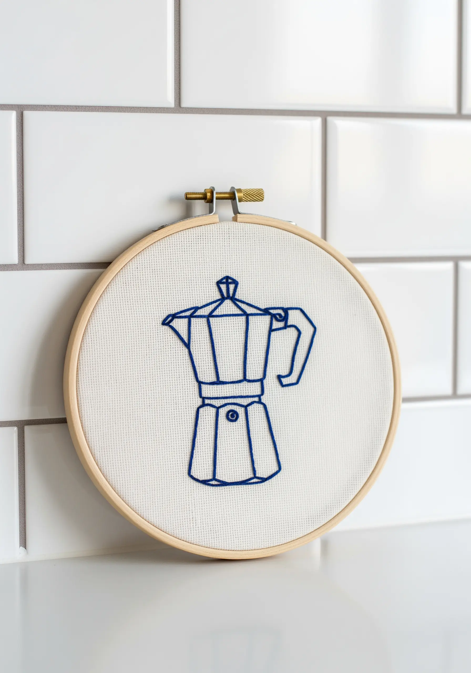 Blue line art embroidery of a Moka coffee pot