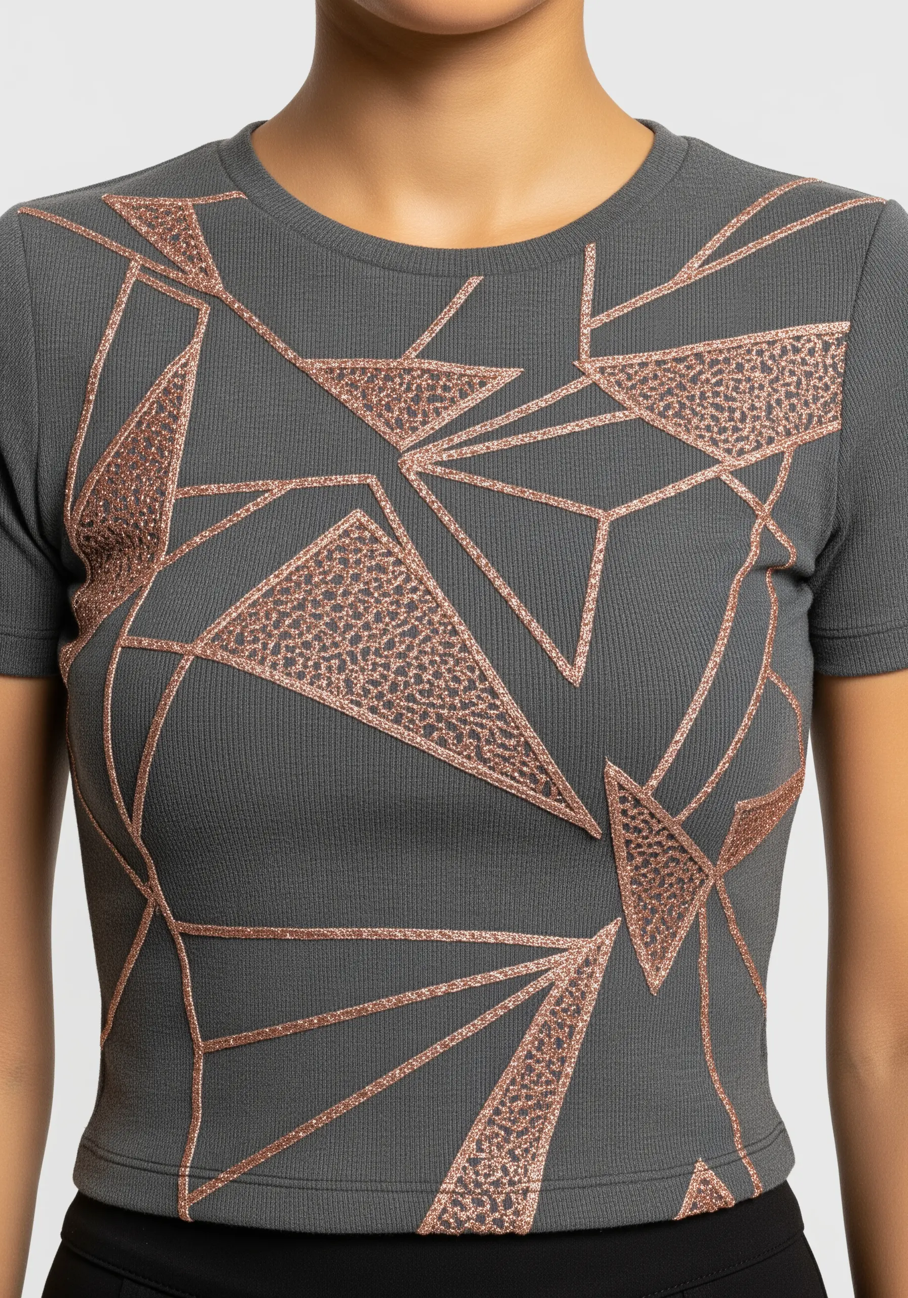 Geometric lines and shapes in rose gold glitter thread on a grey ribbed t-shirt.